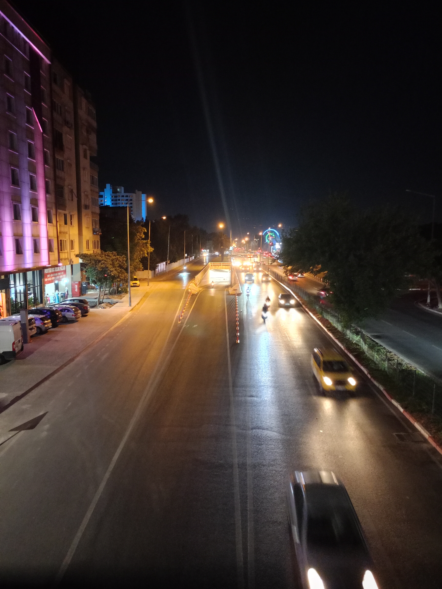 Wet night traffic near Bulvar Hotel, central Antalya