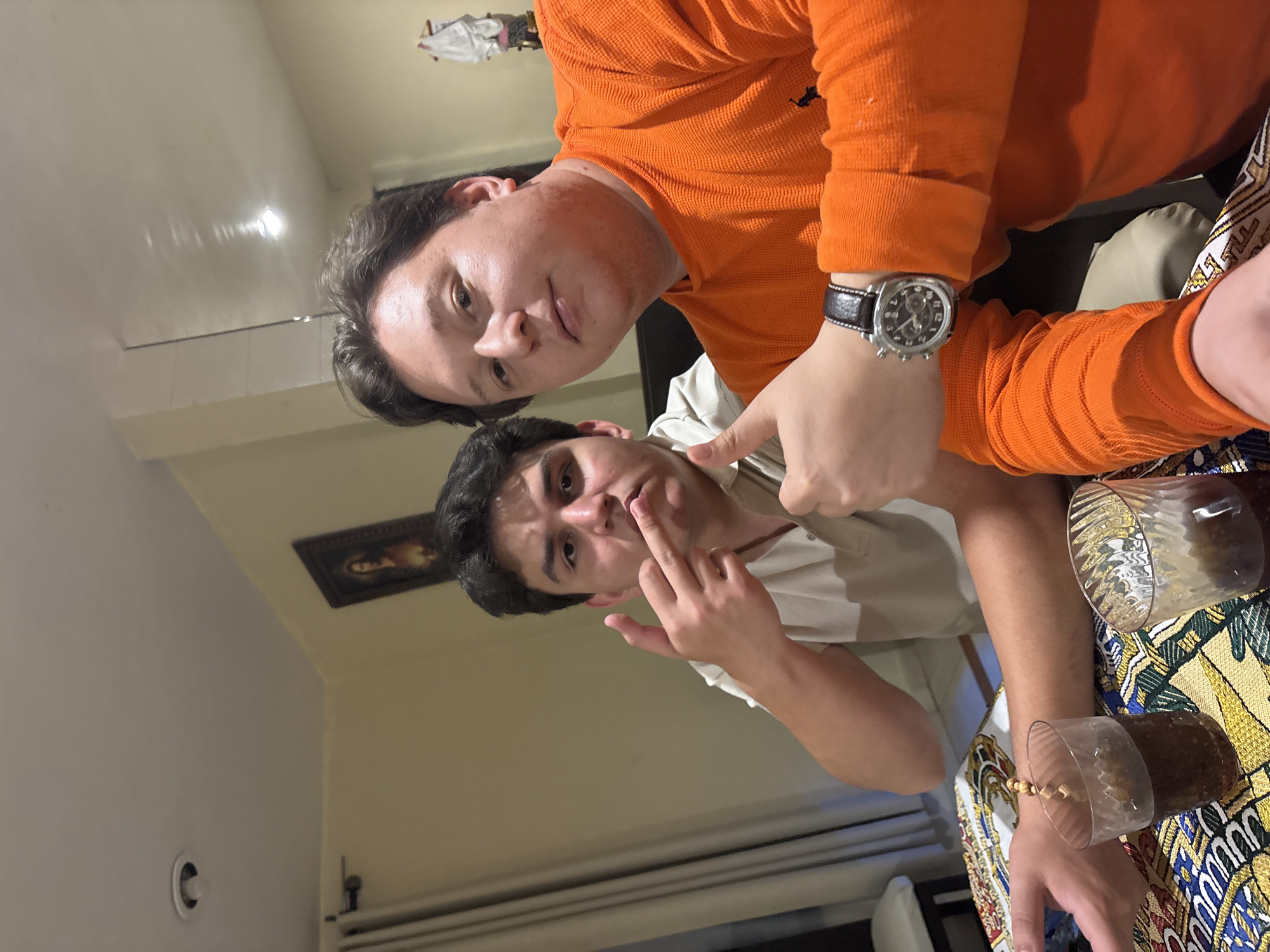 Two men take selfie with drinks in Puebla home