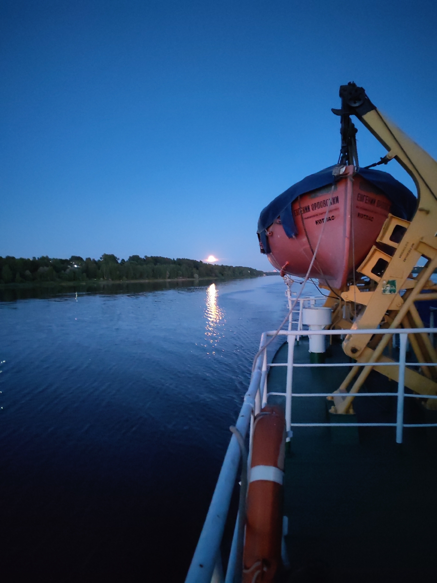 Evening river cruise through forested Ustye, Russia
