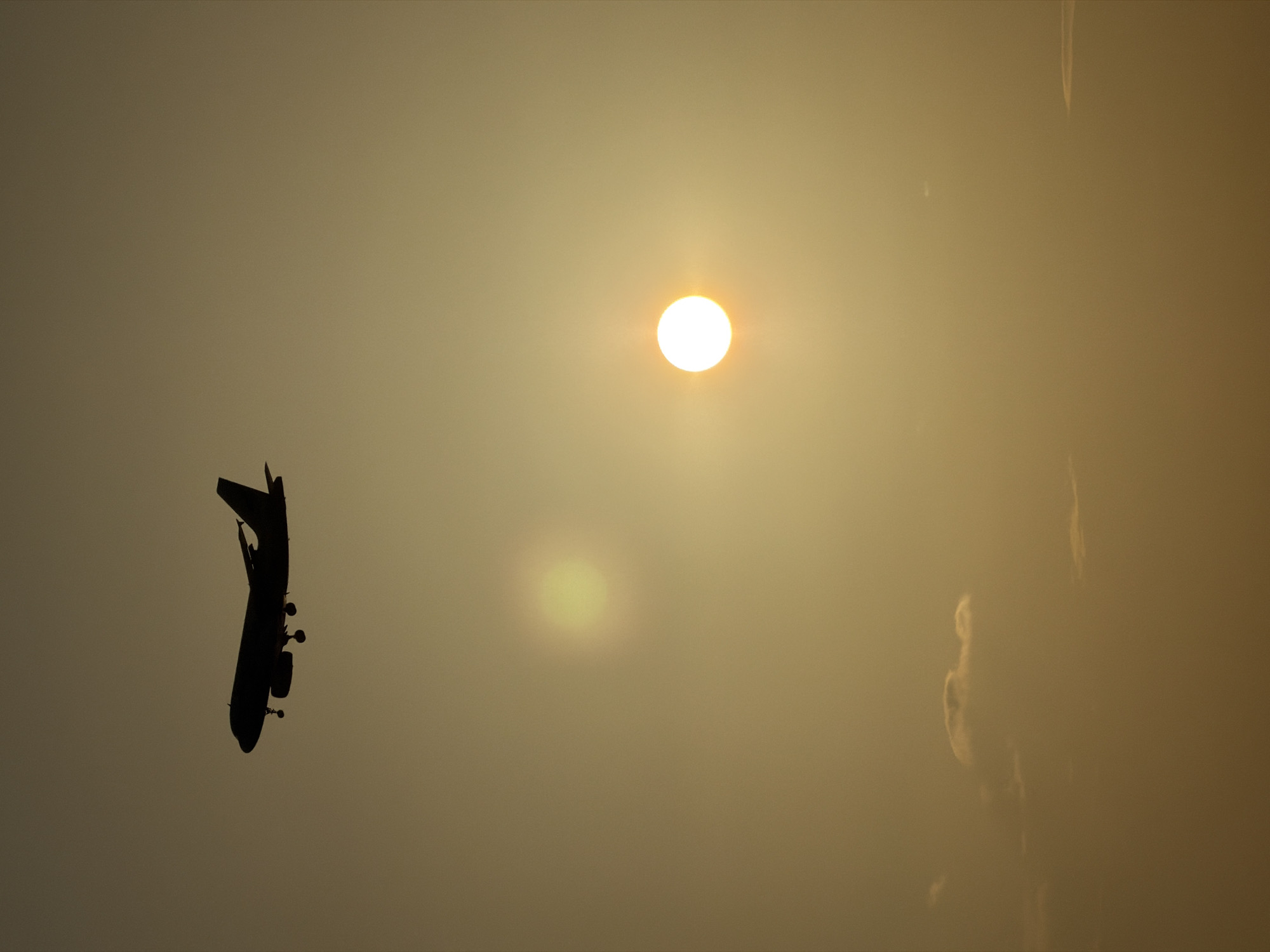 Golden sunset over Ko Samui with a plane on approach