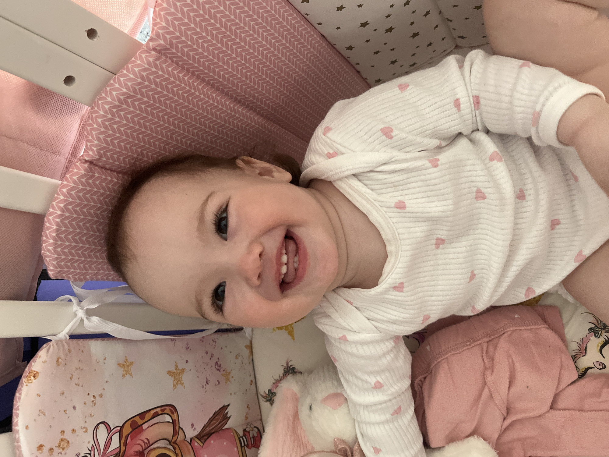 Baby plays and laughs in crib in Shushary