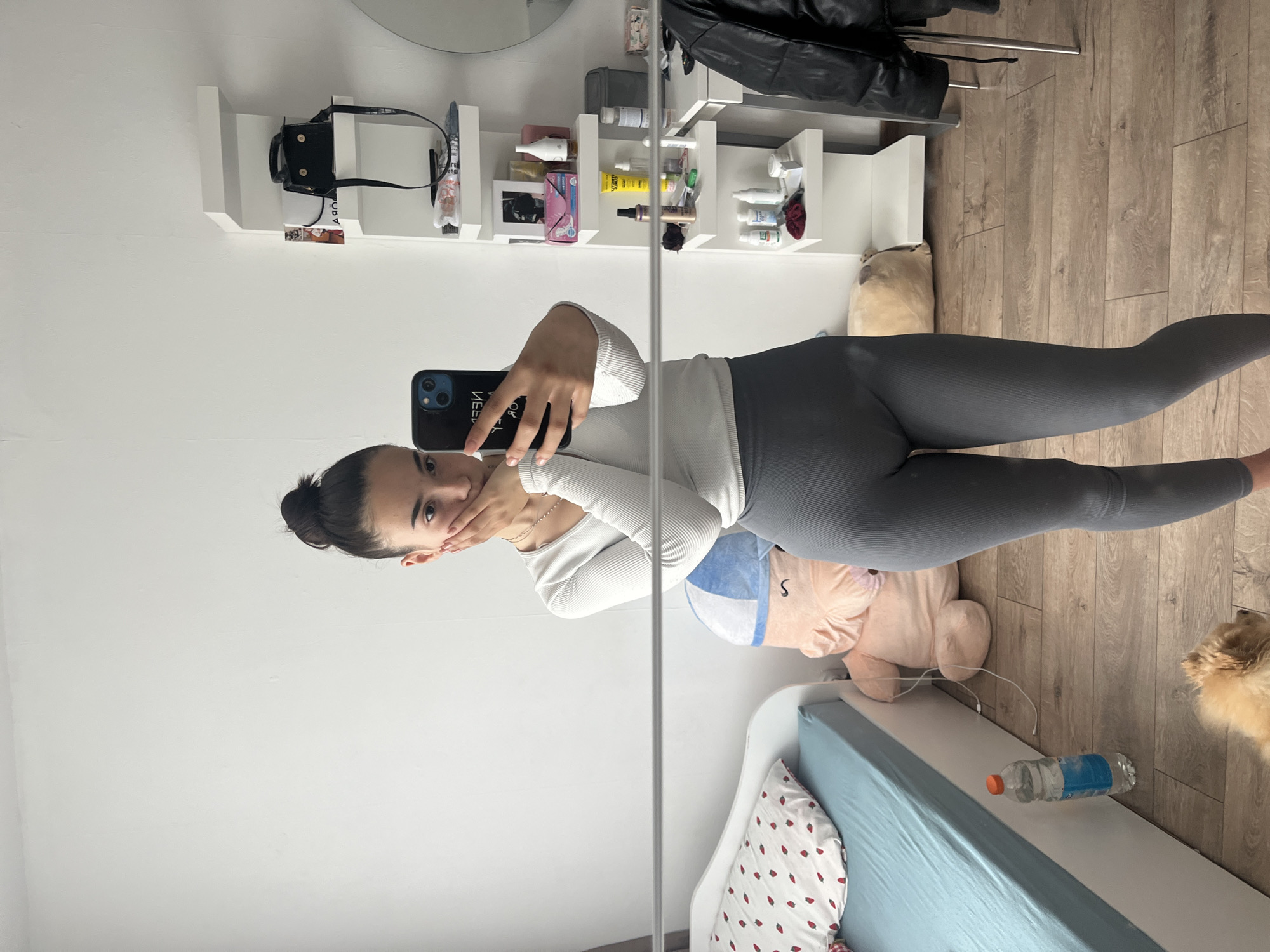 Woman takes mirror selfie in Sofia bedroom
