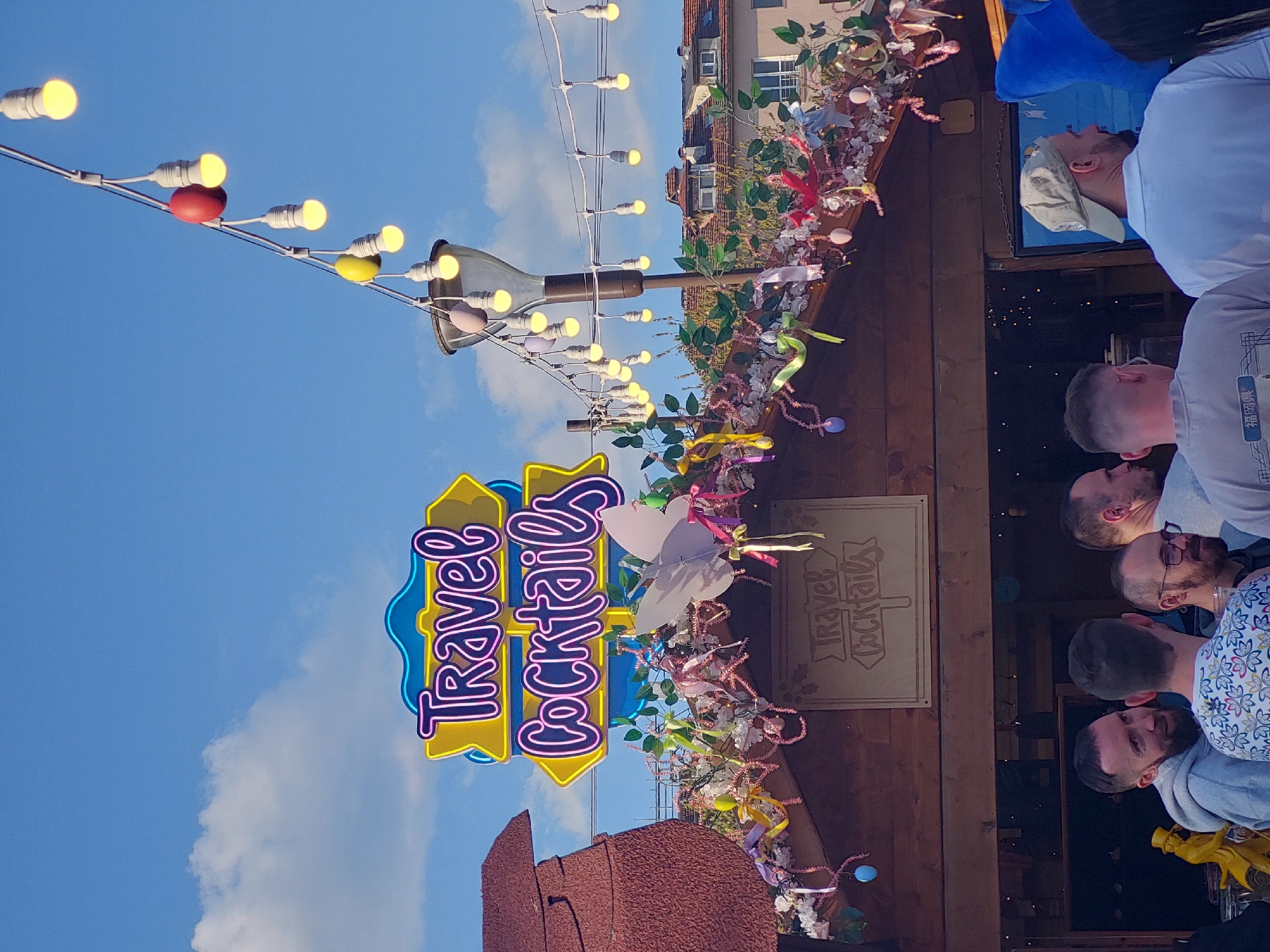 Outdoor market festival documented with Ferris wheel, beverages, murals