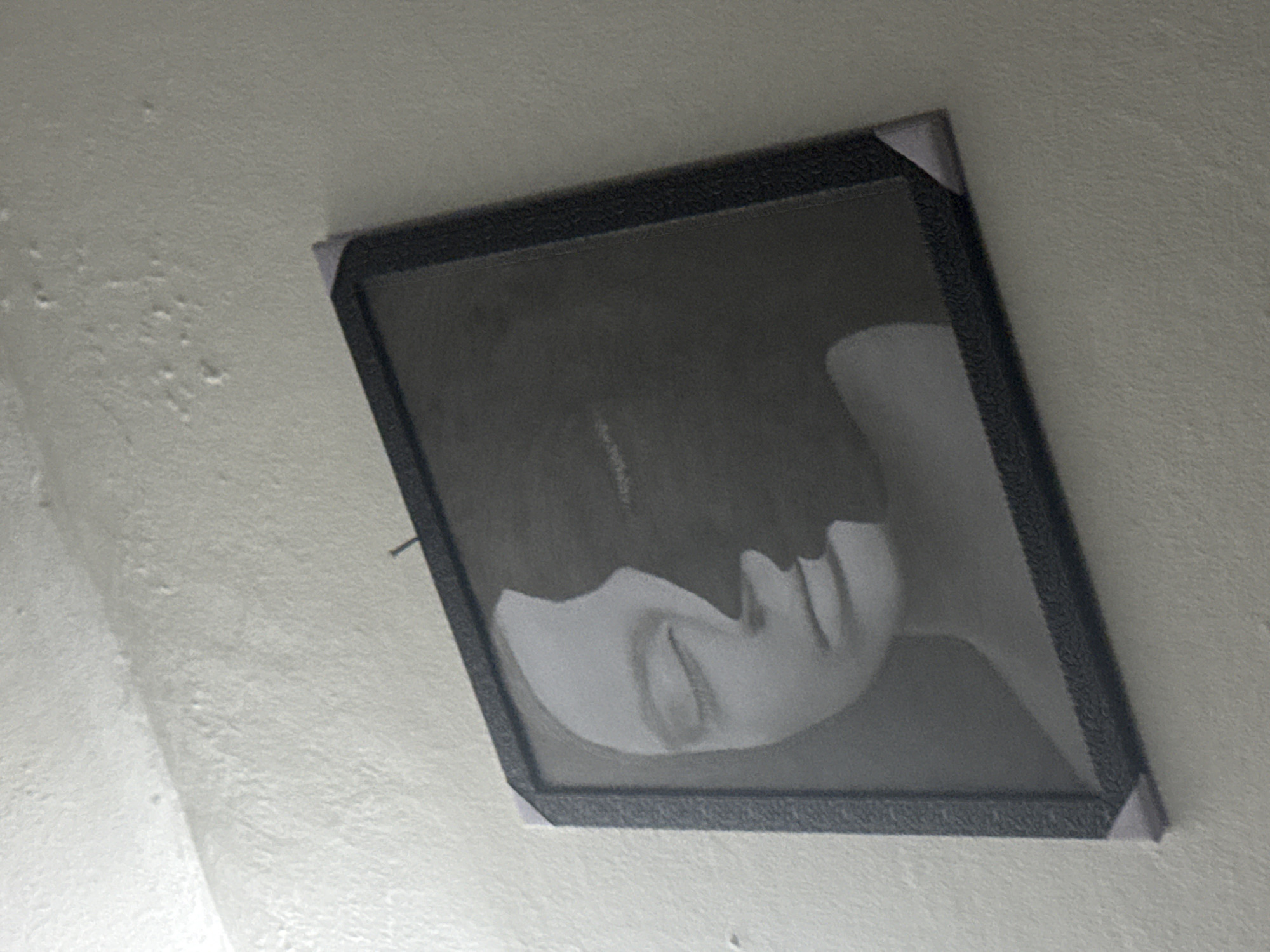 Askew portrait photograph observed on wall in Ihiagwa