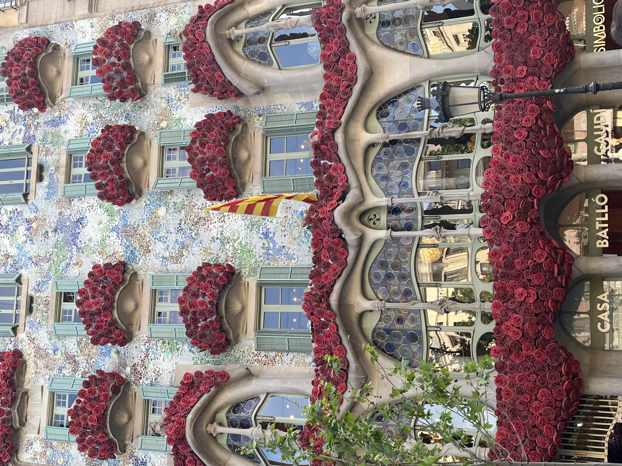 Tourist photographs iconic Gaudí building Casa Batlló in Barcelona