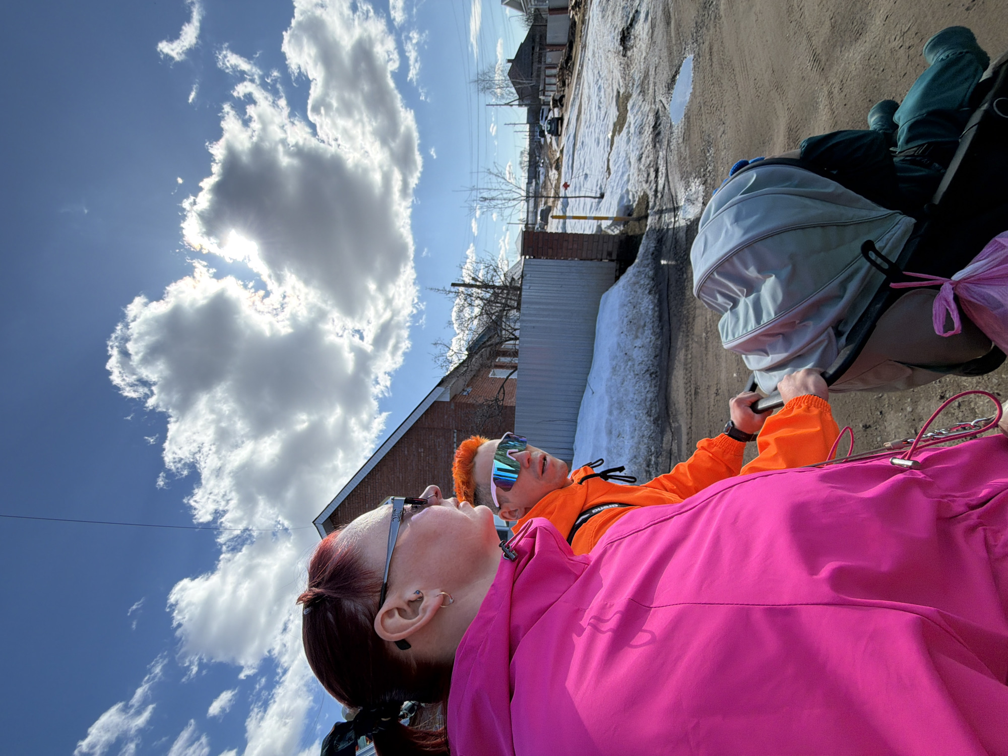 Couple with baby stroller walks residential streets in Chaikovsky