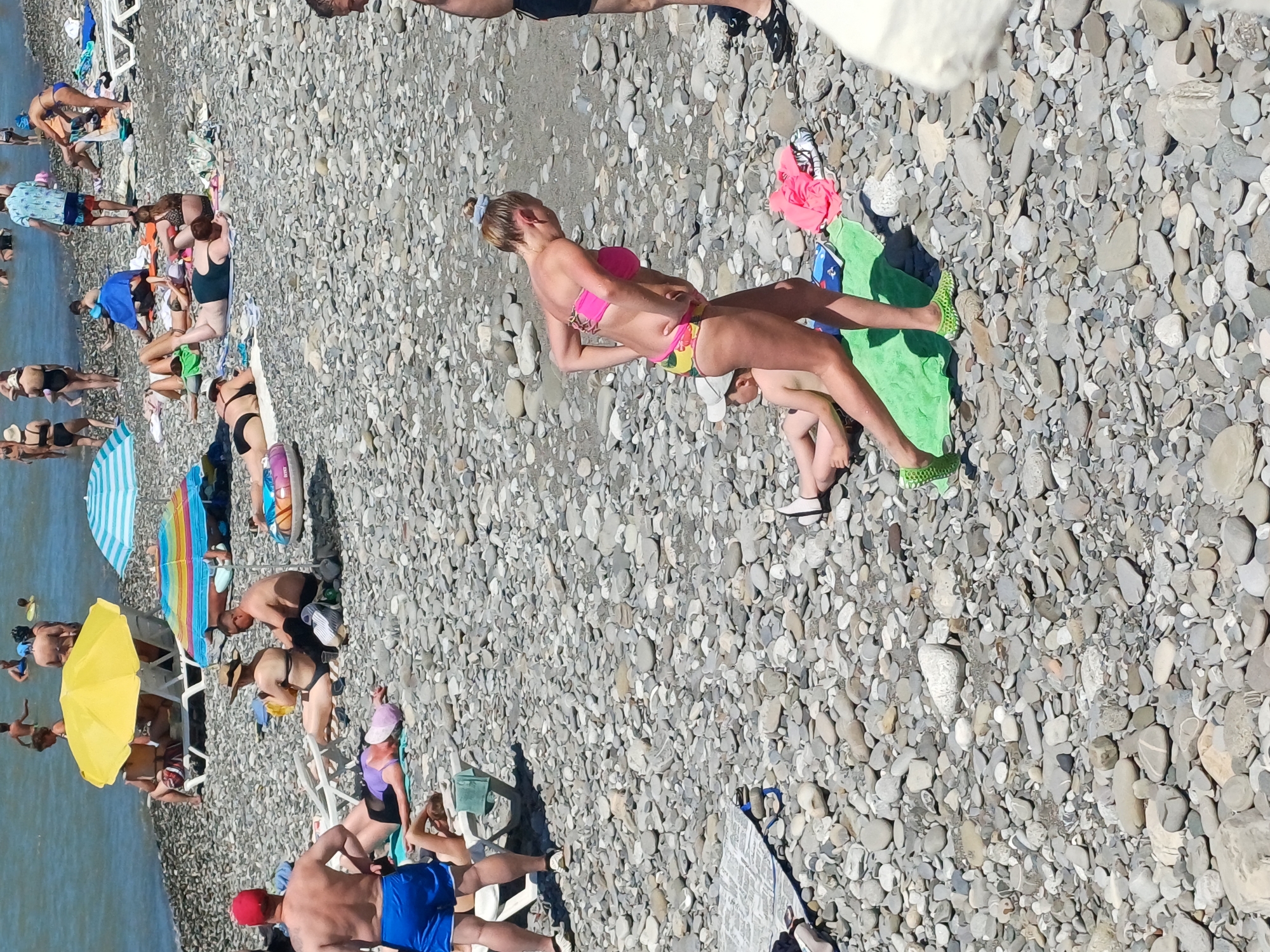 Busy summer morning on Sochi's Black Sea pebble beach