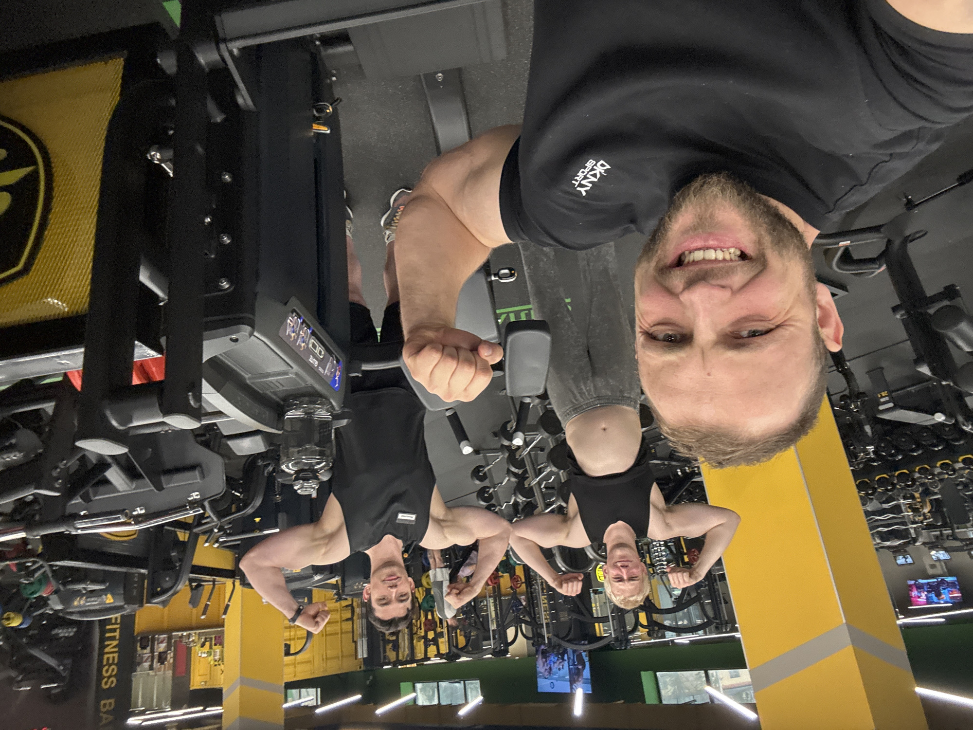 Friends pose for gym selfies during evening workout session