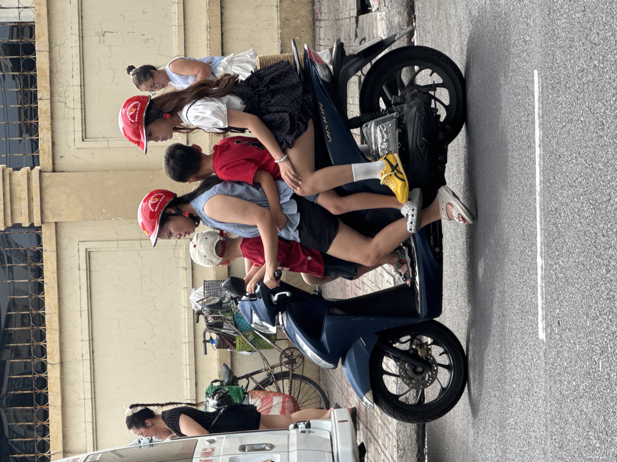 Nha Trang street traffic: scooters, produce, and city skyline
