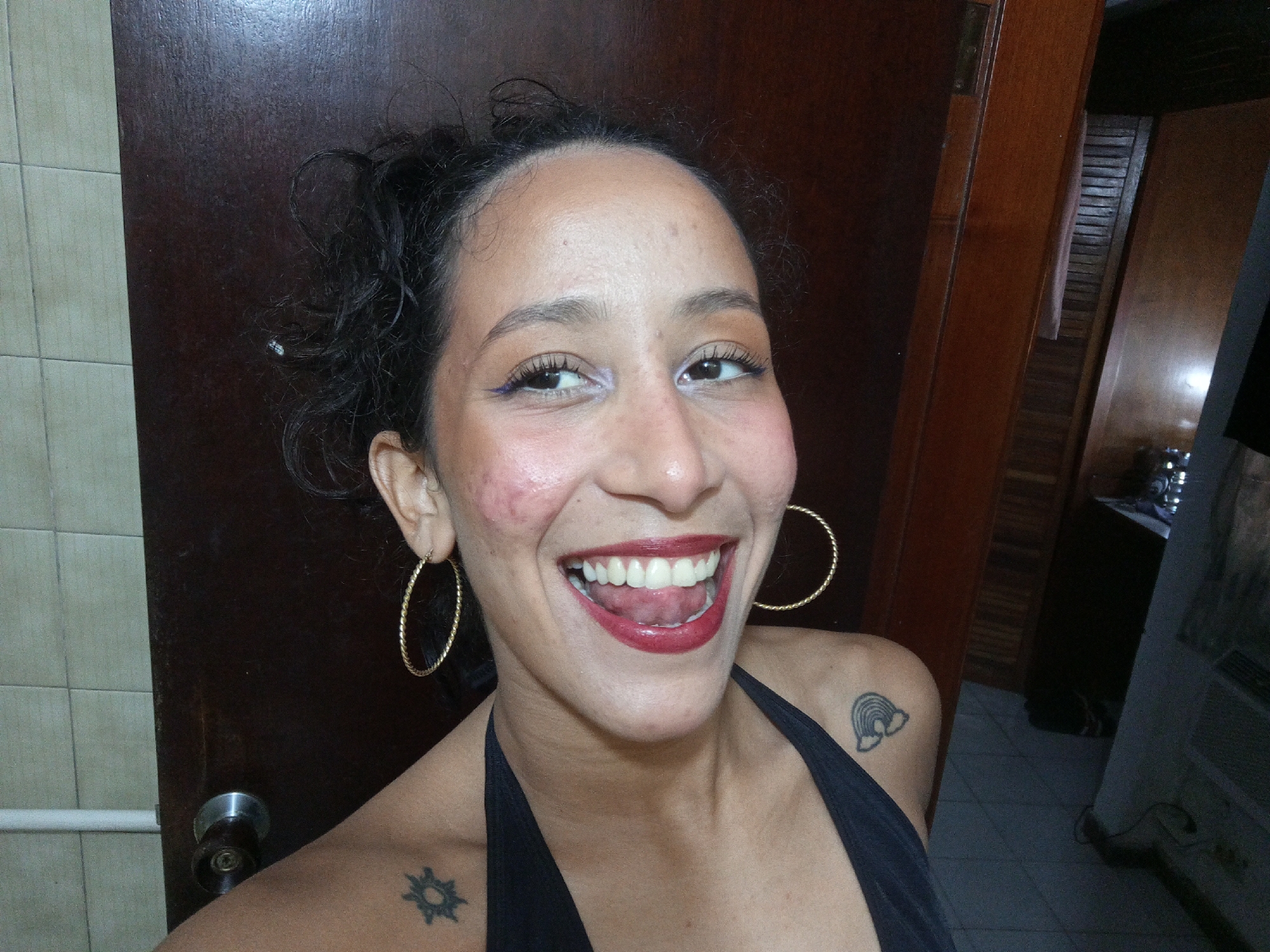 Woman takes selfies among superhero posters in Porlamar