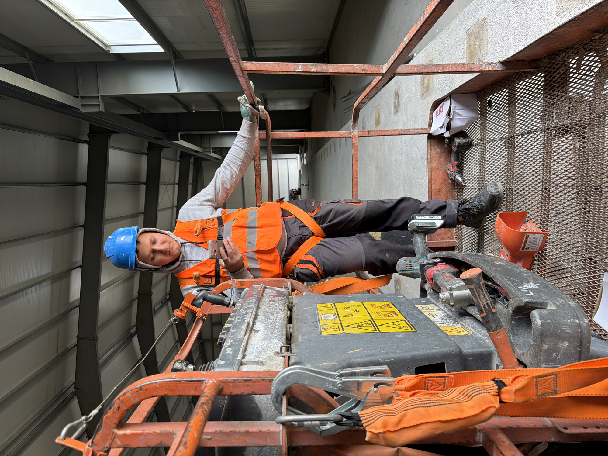 Construction workers take selfies on a job site in Stróża
