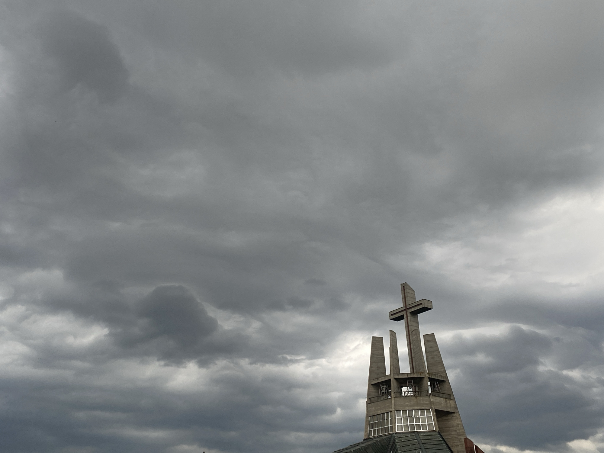Cat naps on a Świdnica patio under cloudy skies