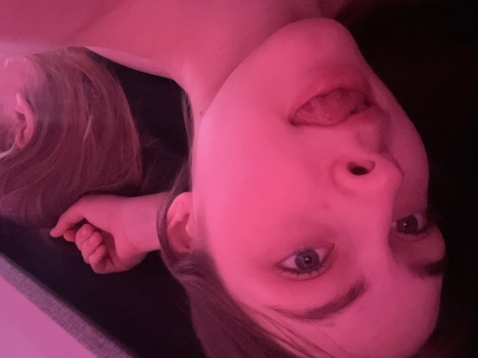 Person photographed under pink lighting in Saint Petersburg room