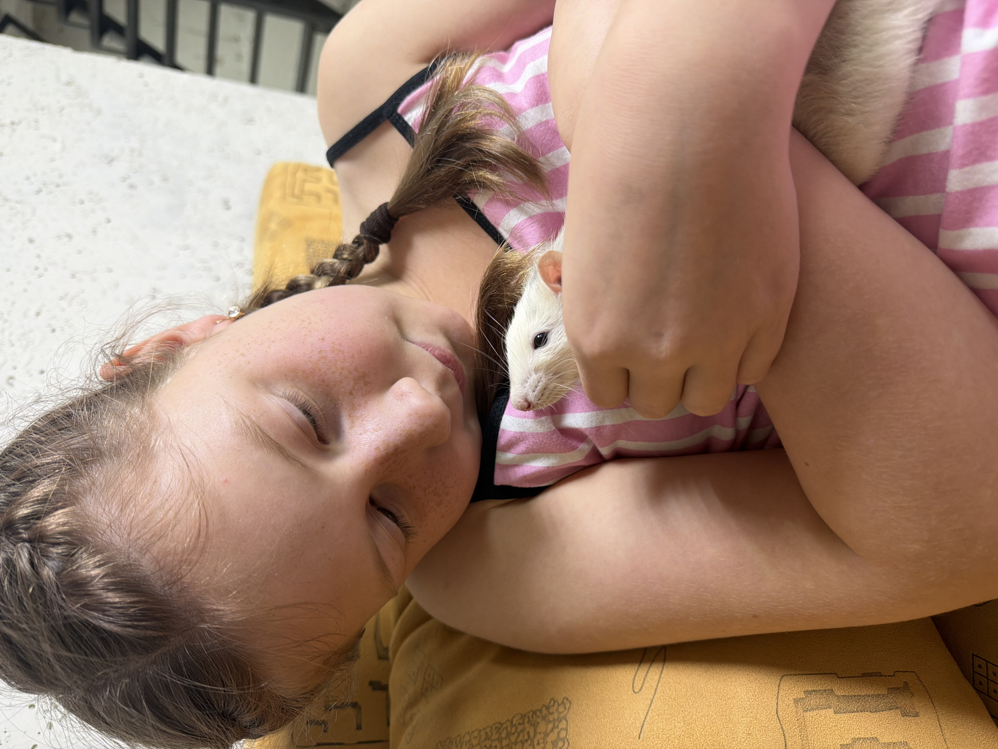Girl bonds with pet rat in quiet moments