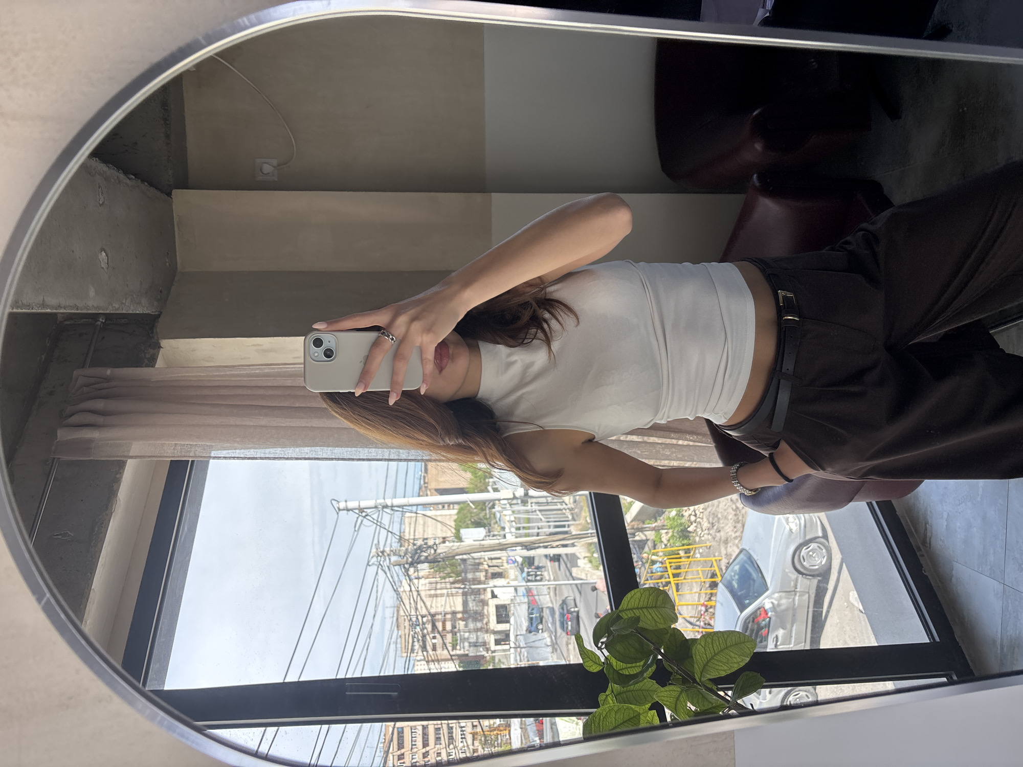 Woman takes mirror selfie indoors in Zovuni, Armenia