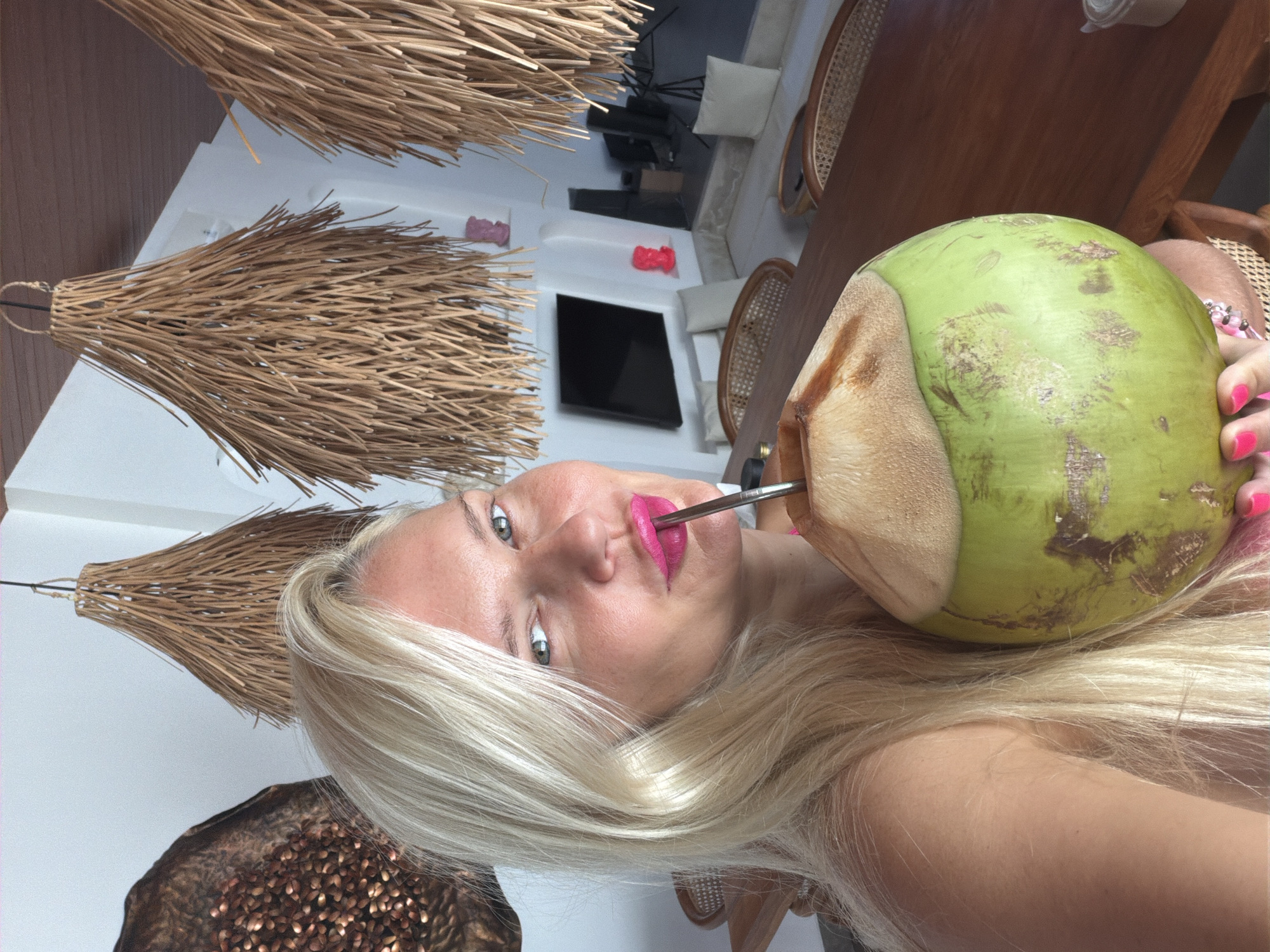 Woman drinks coconut water in Mengwi, Indonesia