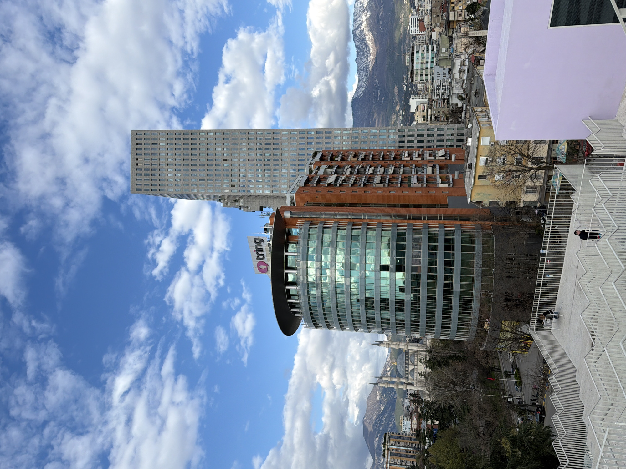 Tourists explore Tirana's rooftops, churches, and art installations