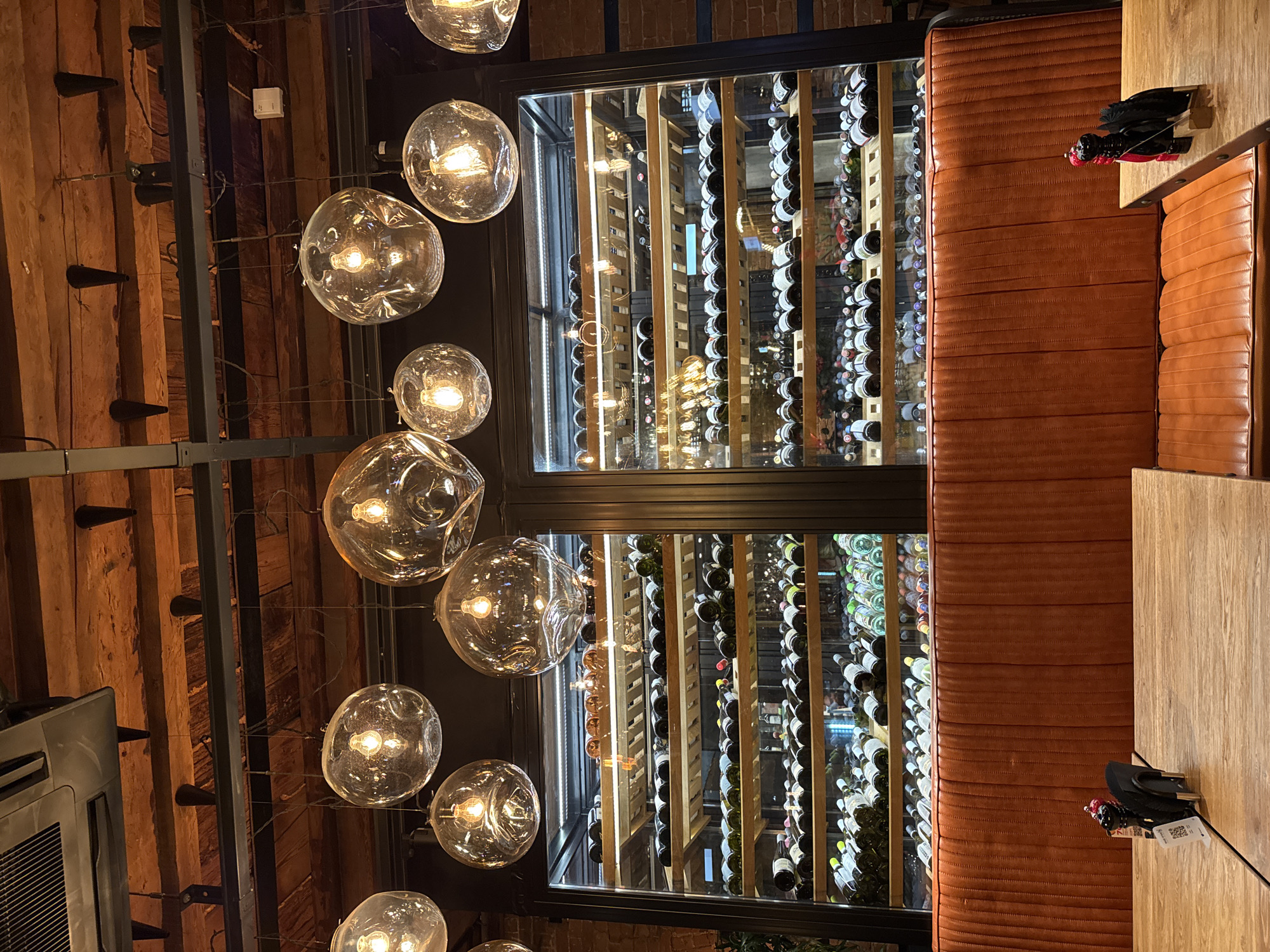 Restaurant bar interior captured with wine rack and entertainment features