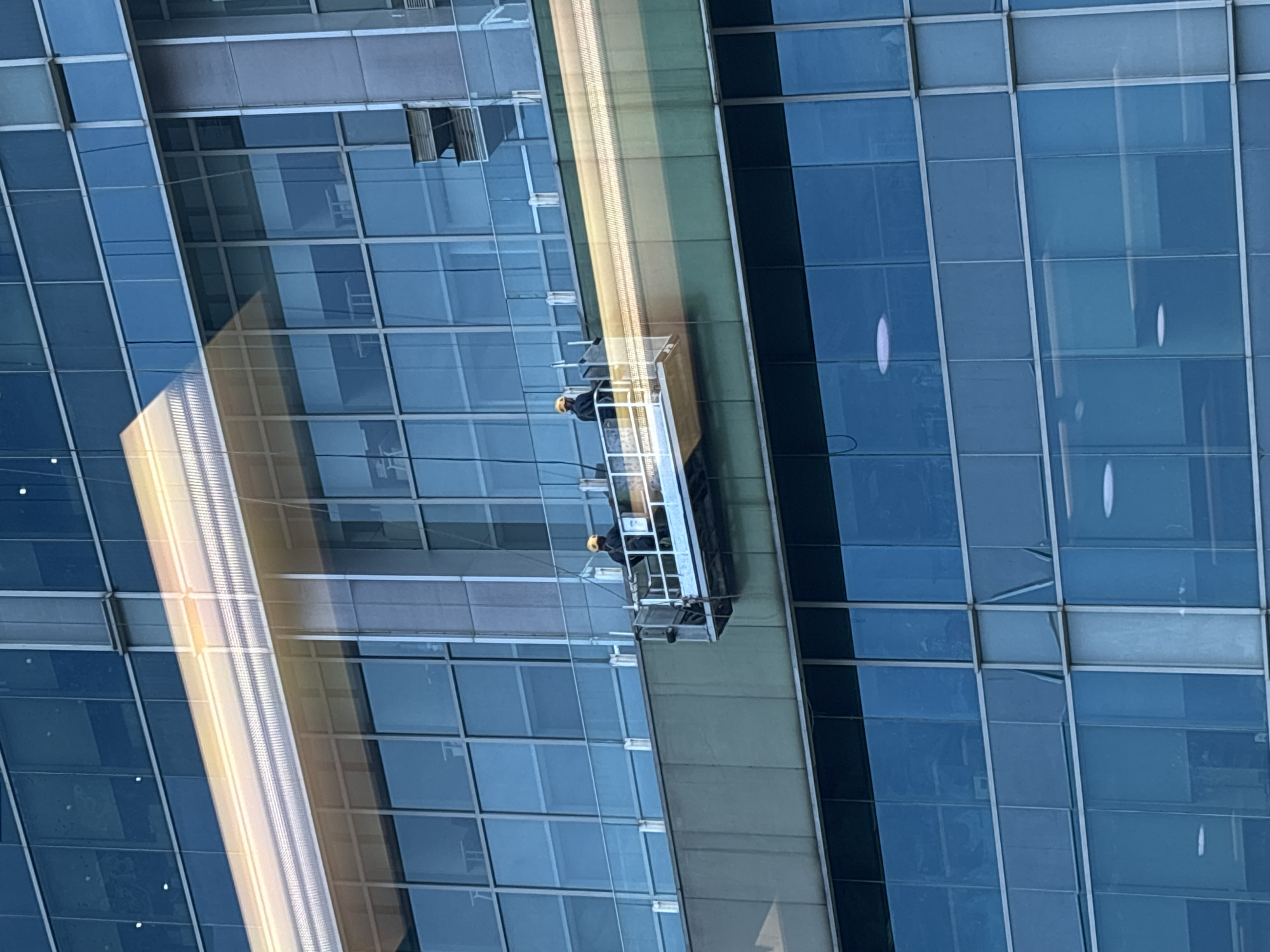 Window washers clean Jakarta high-rise in early morning hours