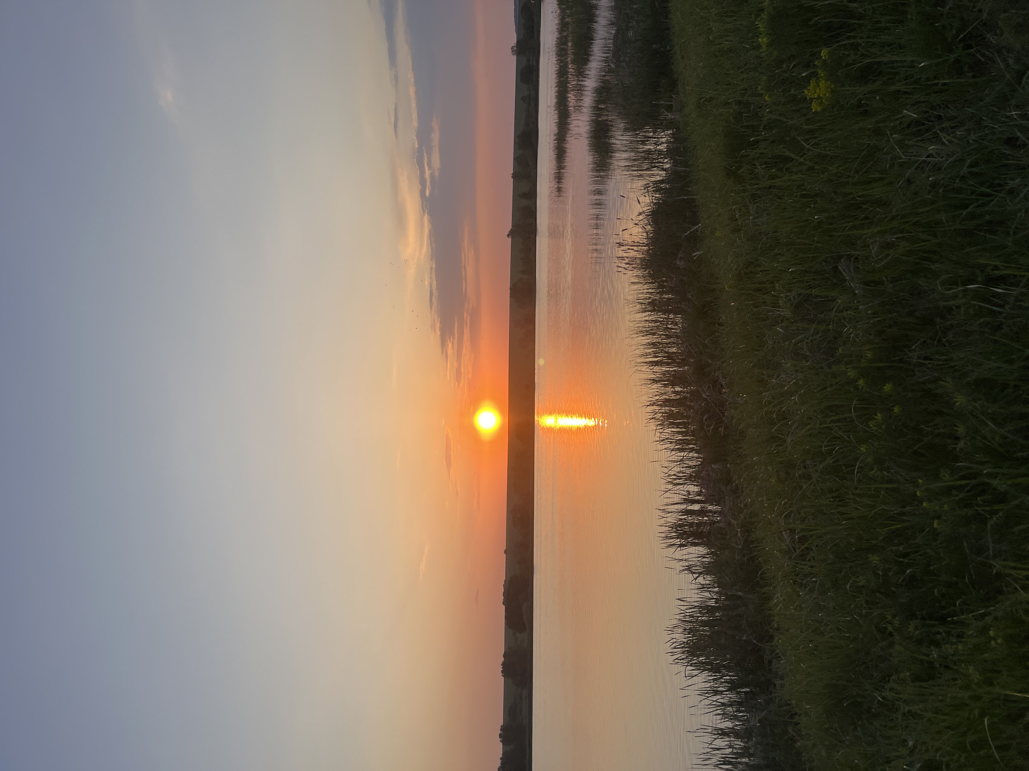 Sunset observed over water in Shuvalovka, Russia