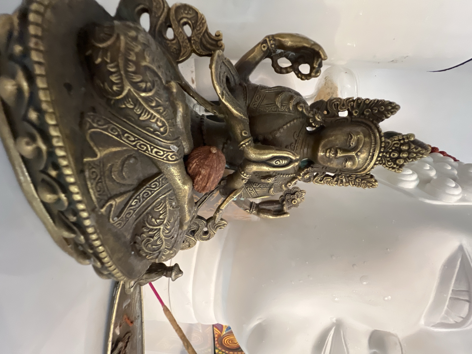 Buddhist and Hindu statues with burning incense in Petrozavodsk