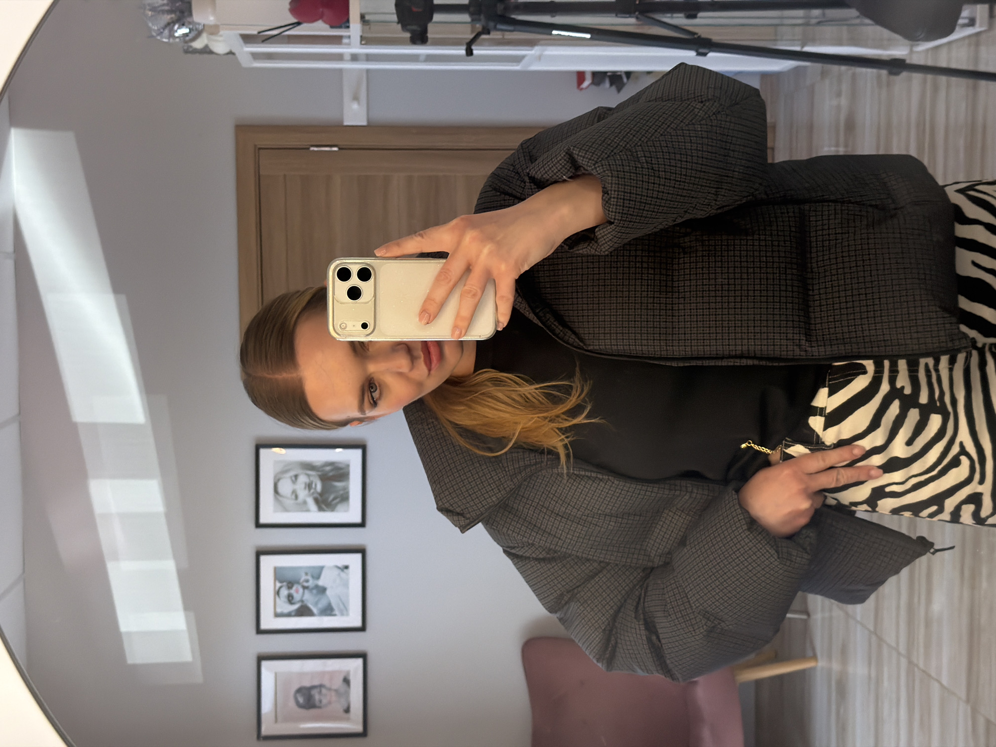 Woman documents zebra-striped outfit in Riga morning fashion shoot