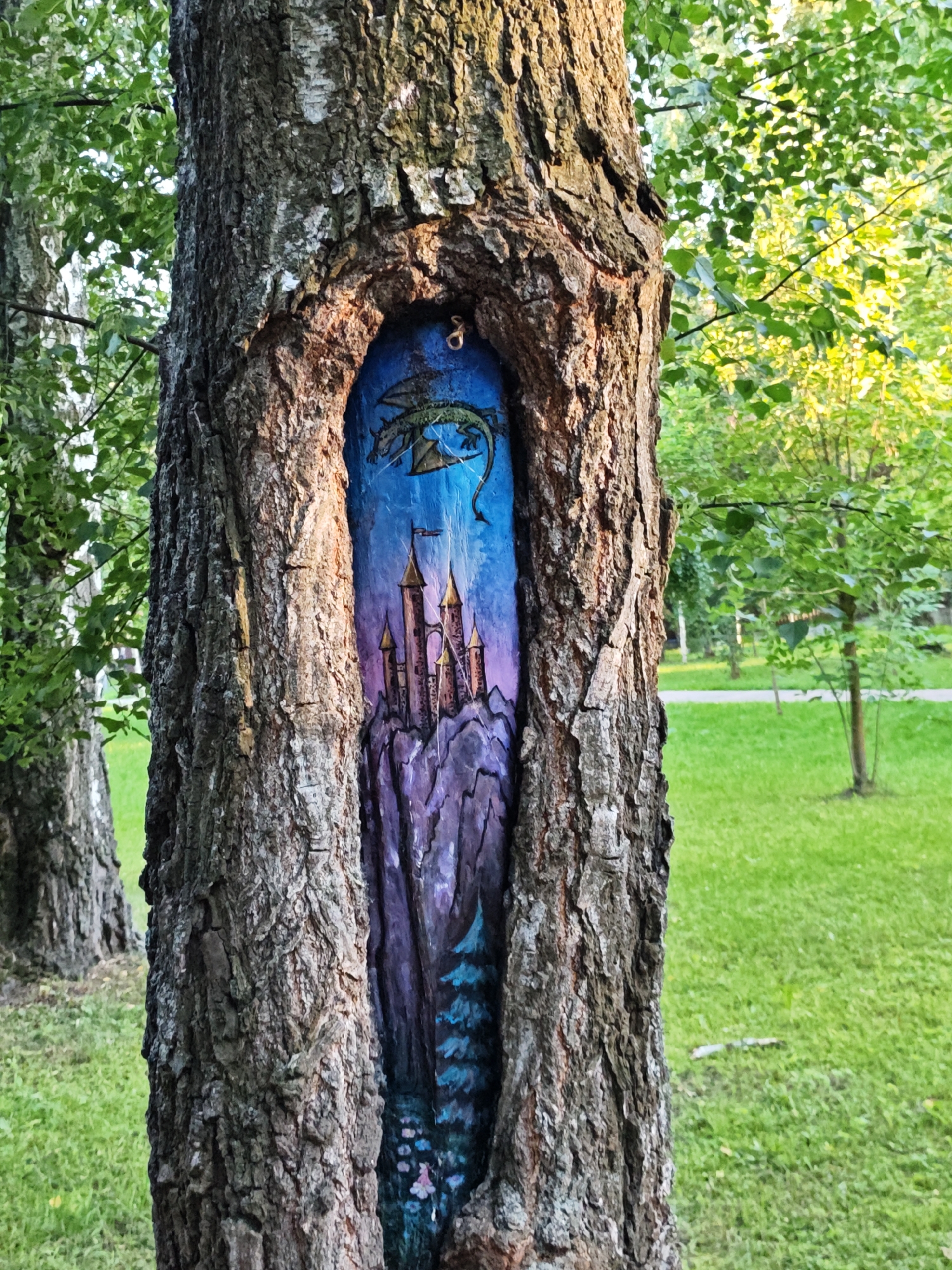 Fantasy murals painted into tree trunks in a Shcherbinka park