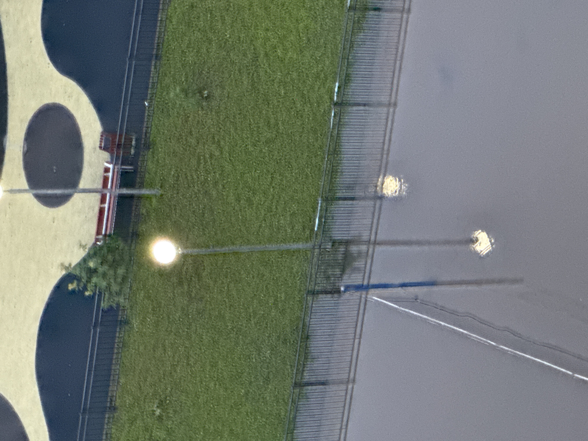 Flooded volleyball court reflects street lamps under stormy Sinyavino skies