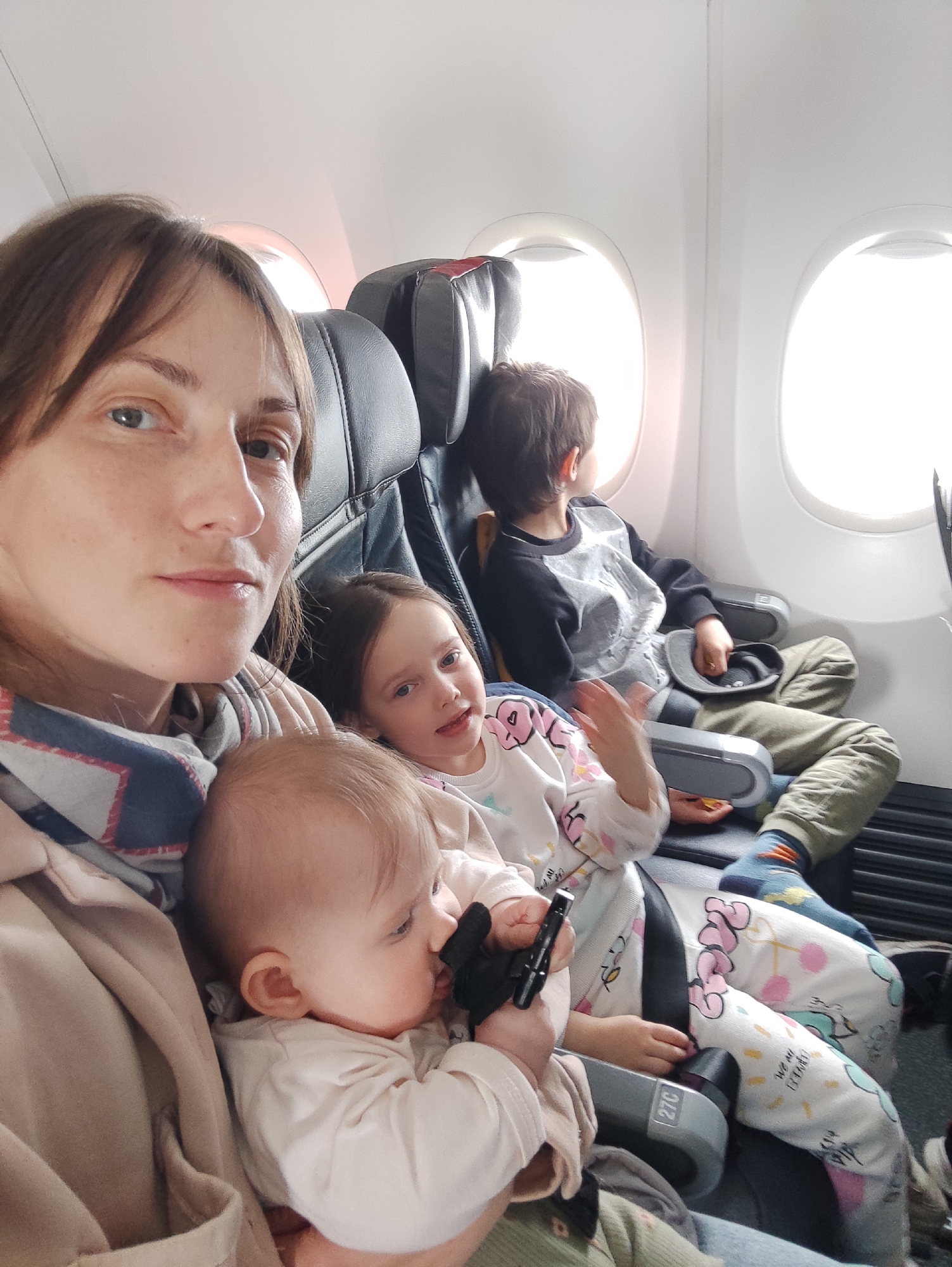 Family travels by air with children during morning flight