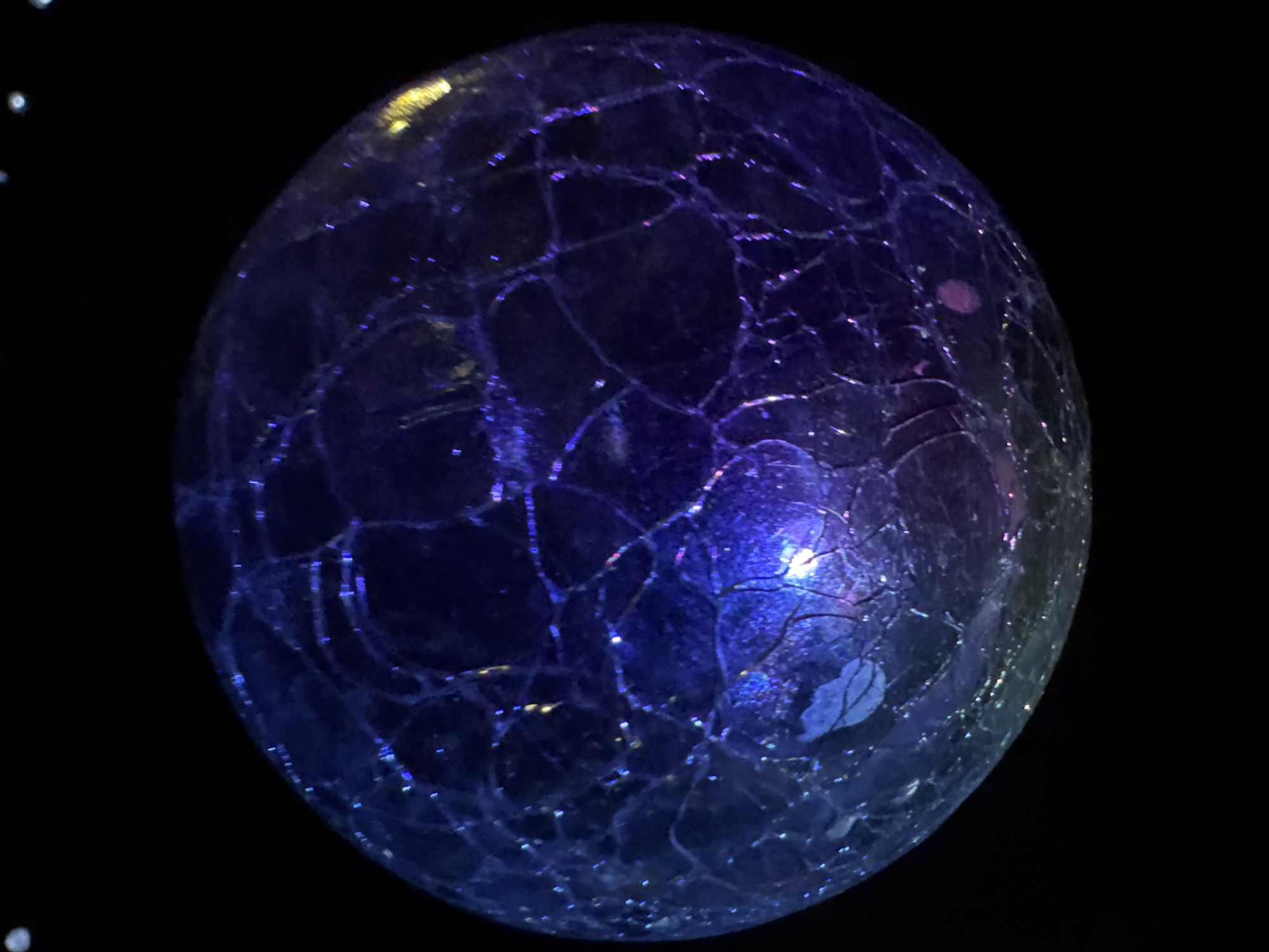 Macro shots of glowing cracked glass spheres in rural Bulgaria