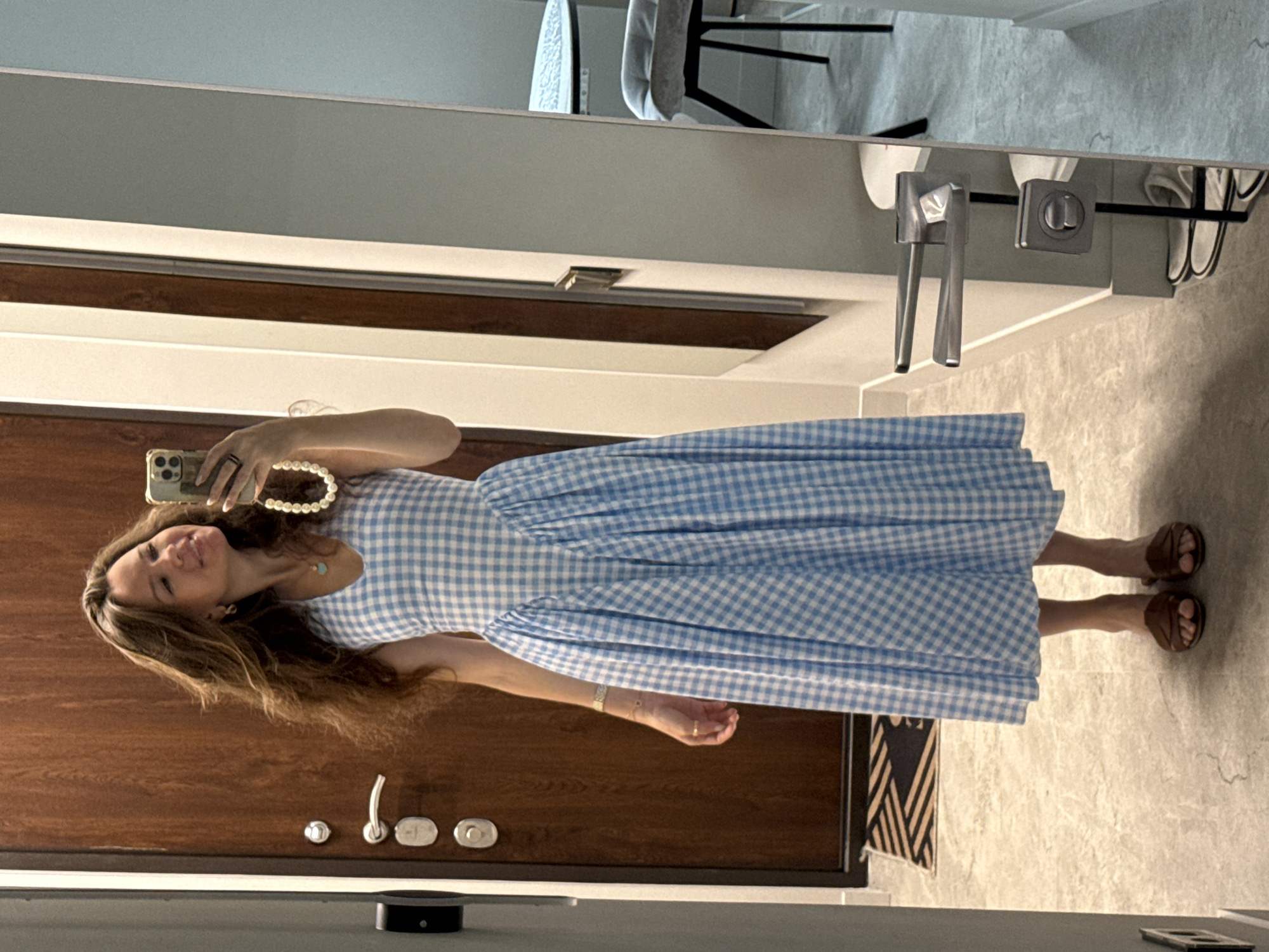 Mirror selfie in a hallway, blue gingham dress