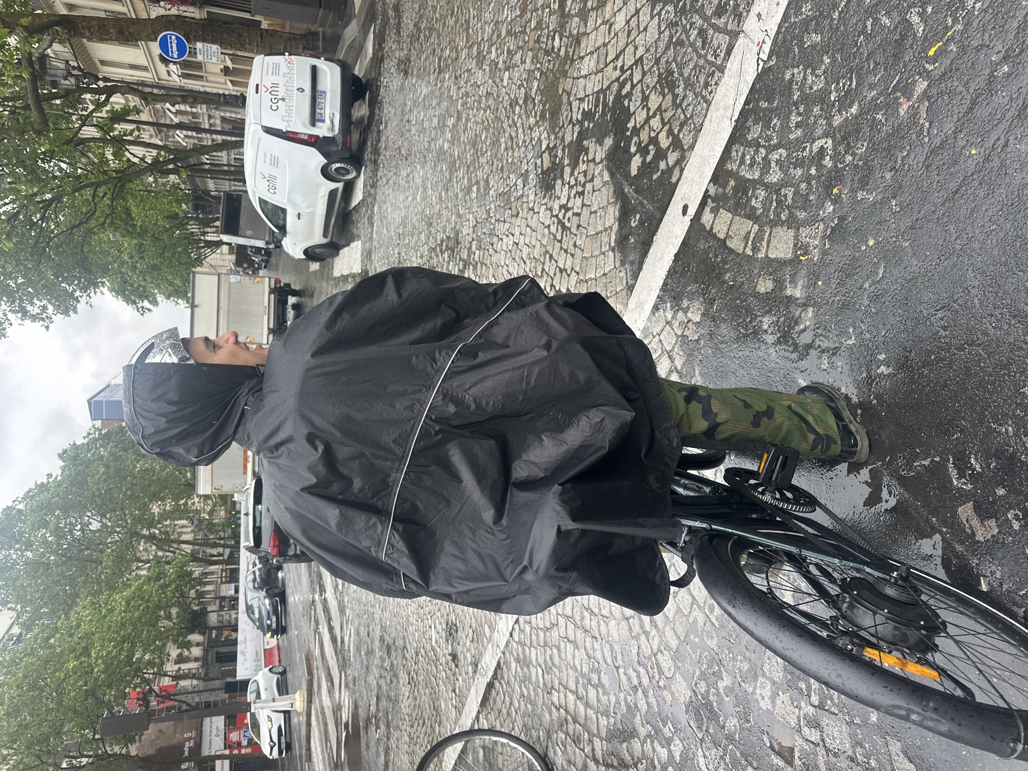 Morning rain brings umbrellas and ponchos to Paris streets