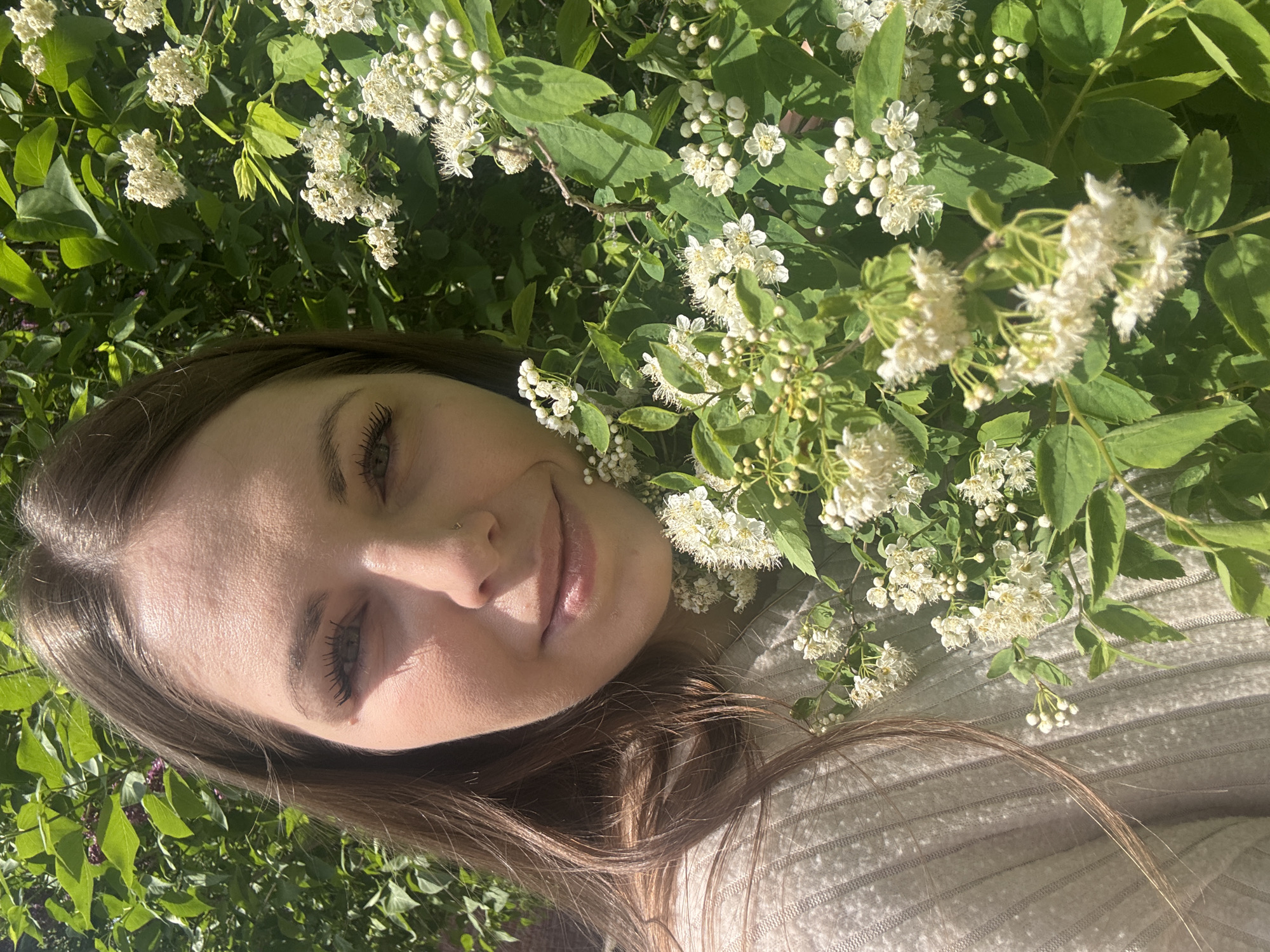 Woman documents spring day among blooming trees in Shevlyakovo