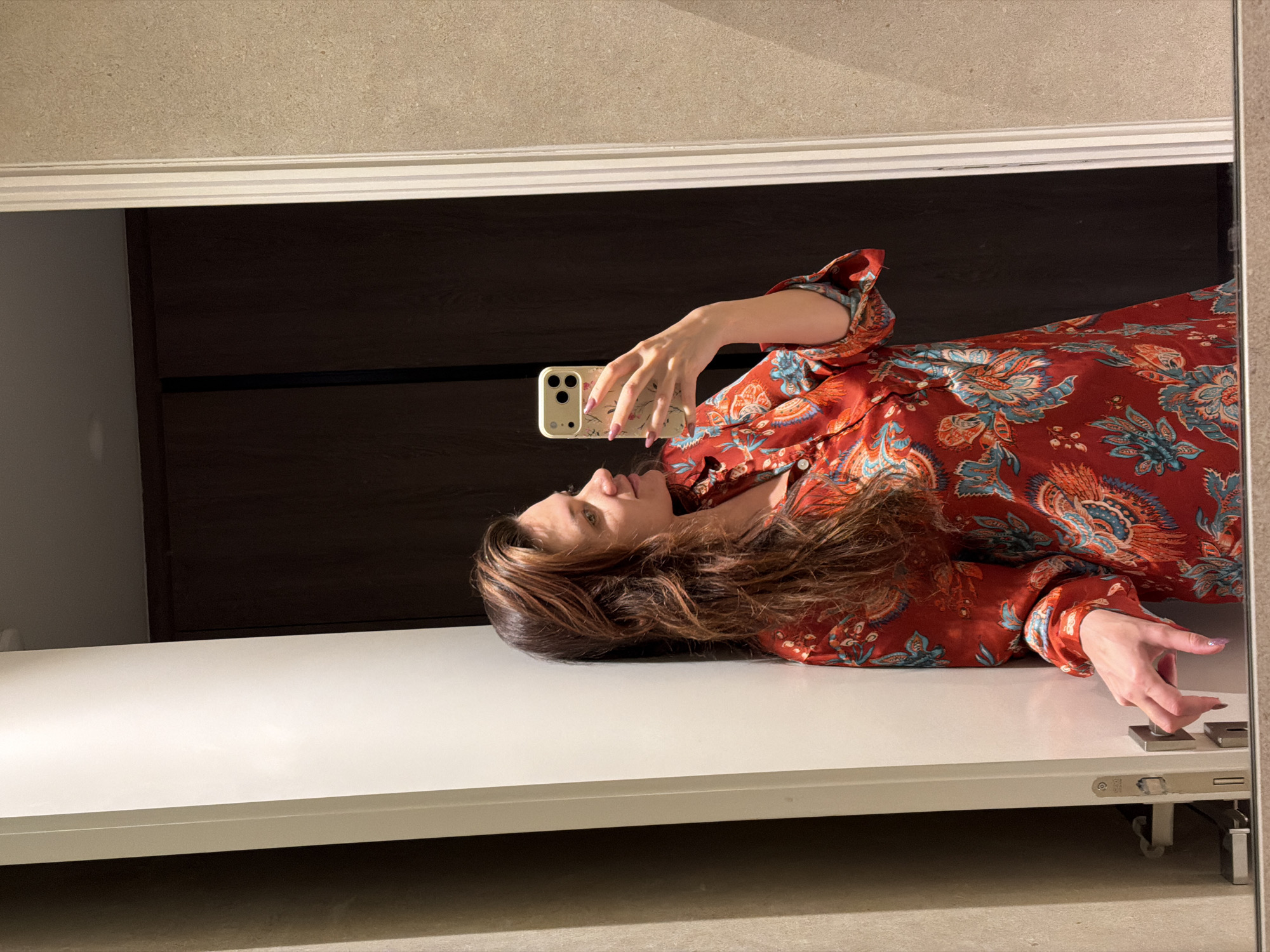 Woman takes bathroom mirror selfie in Athens