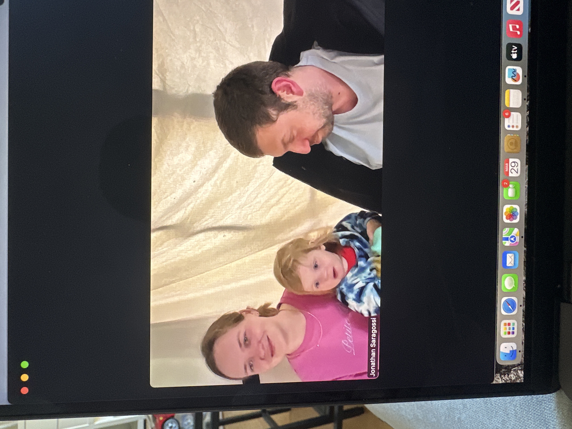 Family video call captured on computer screen in Milan