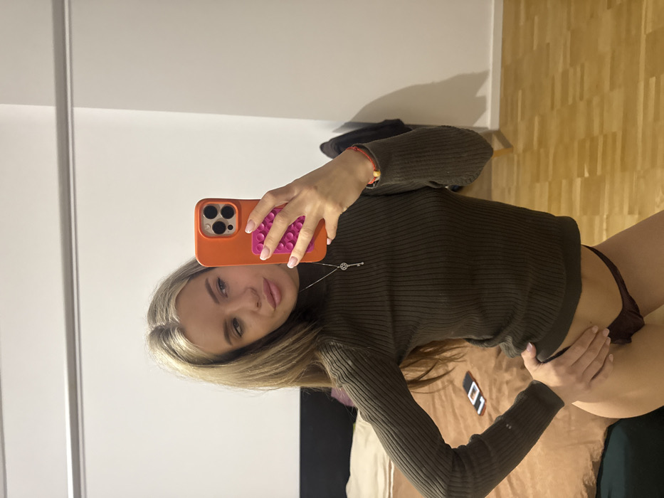 Woman takes multiple selfies in Berlin bedroom