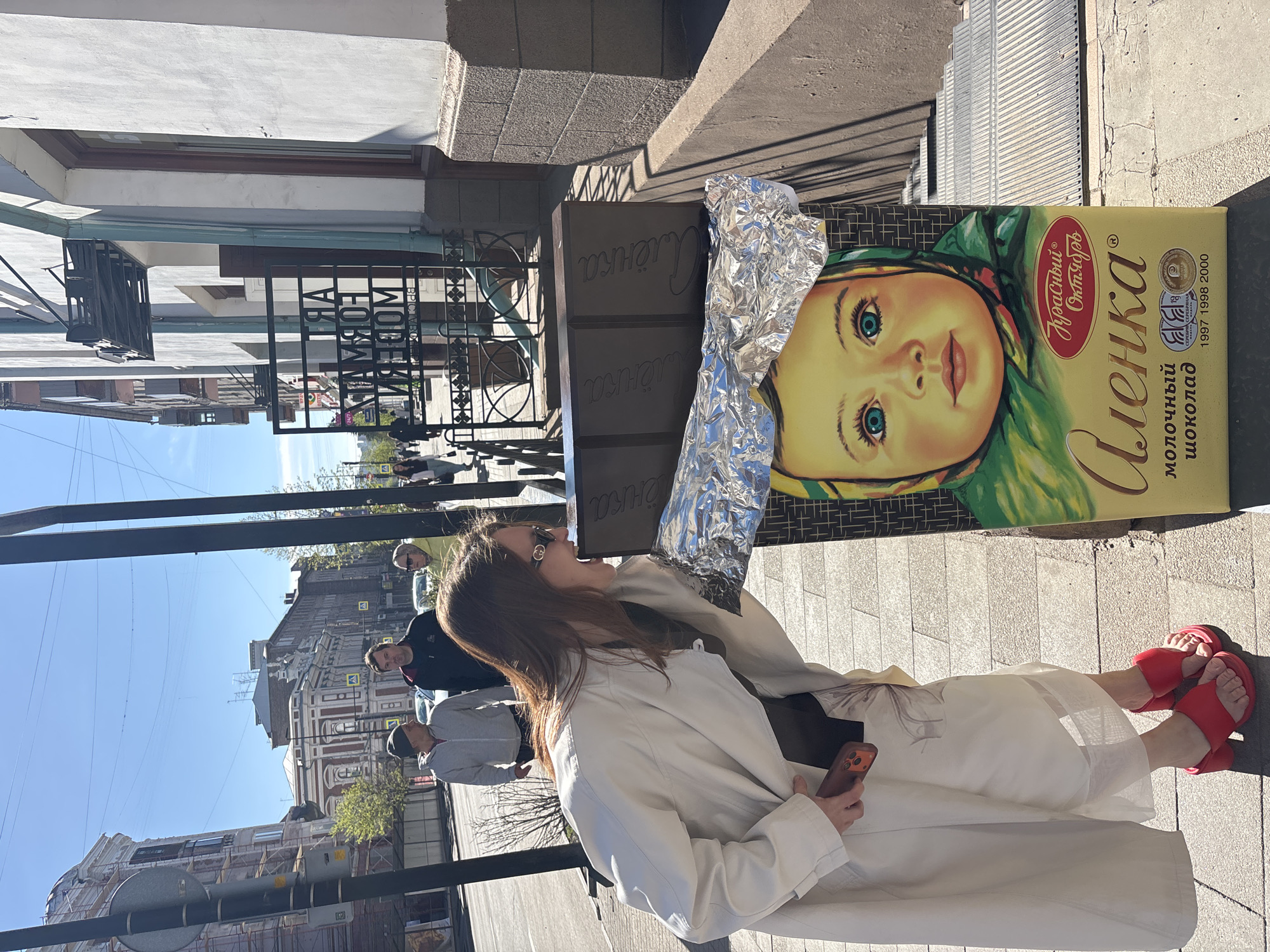 Woman spotted near chocolate ad, food display documented in Krasnoyarsk