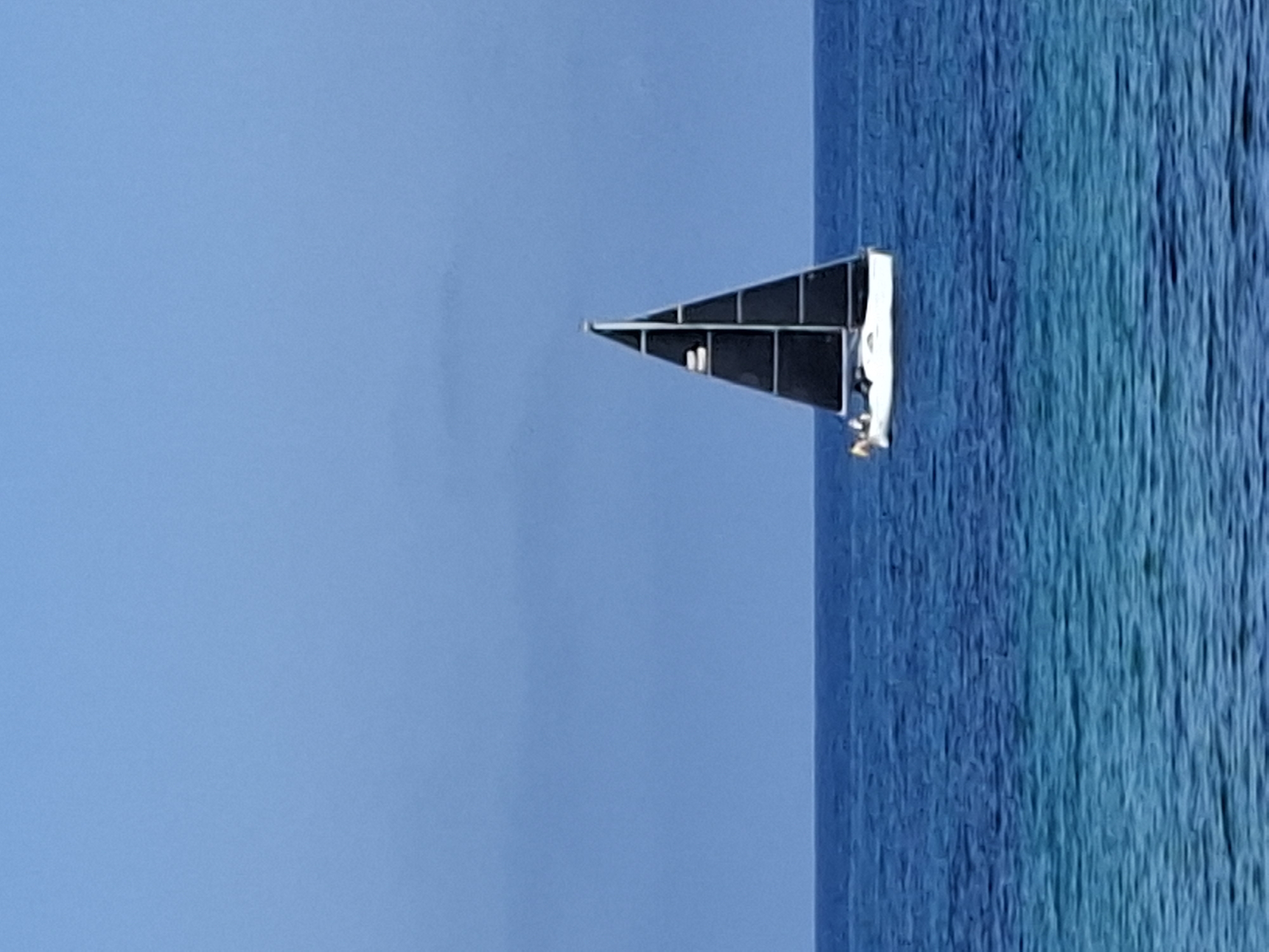 Sunny afternoon in Torrevieja: sailboat, sea, and Spanish architecture