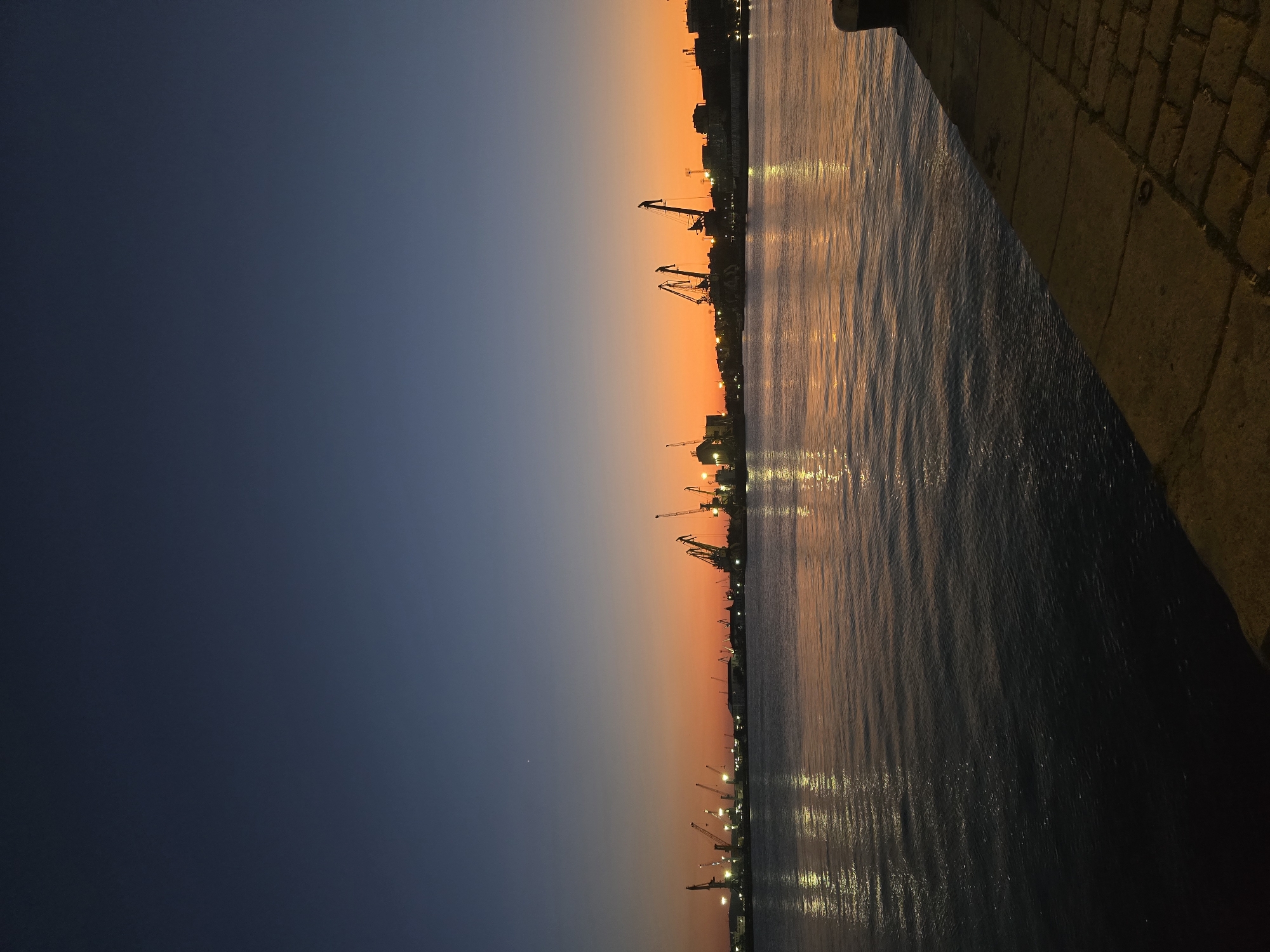 Burgas waterfront at dusk: harbor and cafe under a vivid sunset