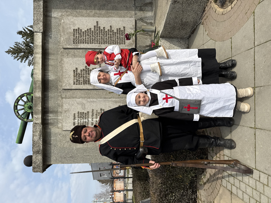 Visitors pose at Slivnitsa war memorial in Bulgaria