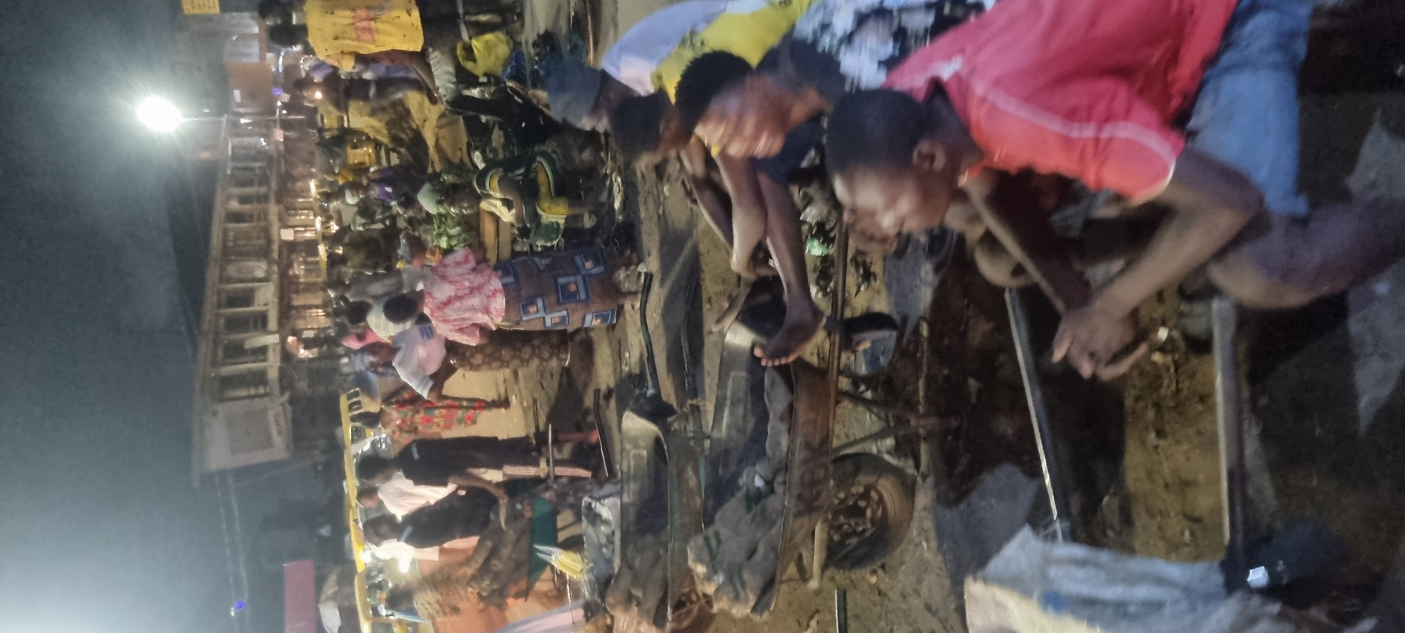 Evening street scenes observed in Lagos include vehicle incident, clothing vendors