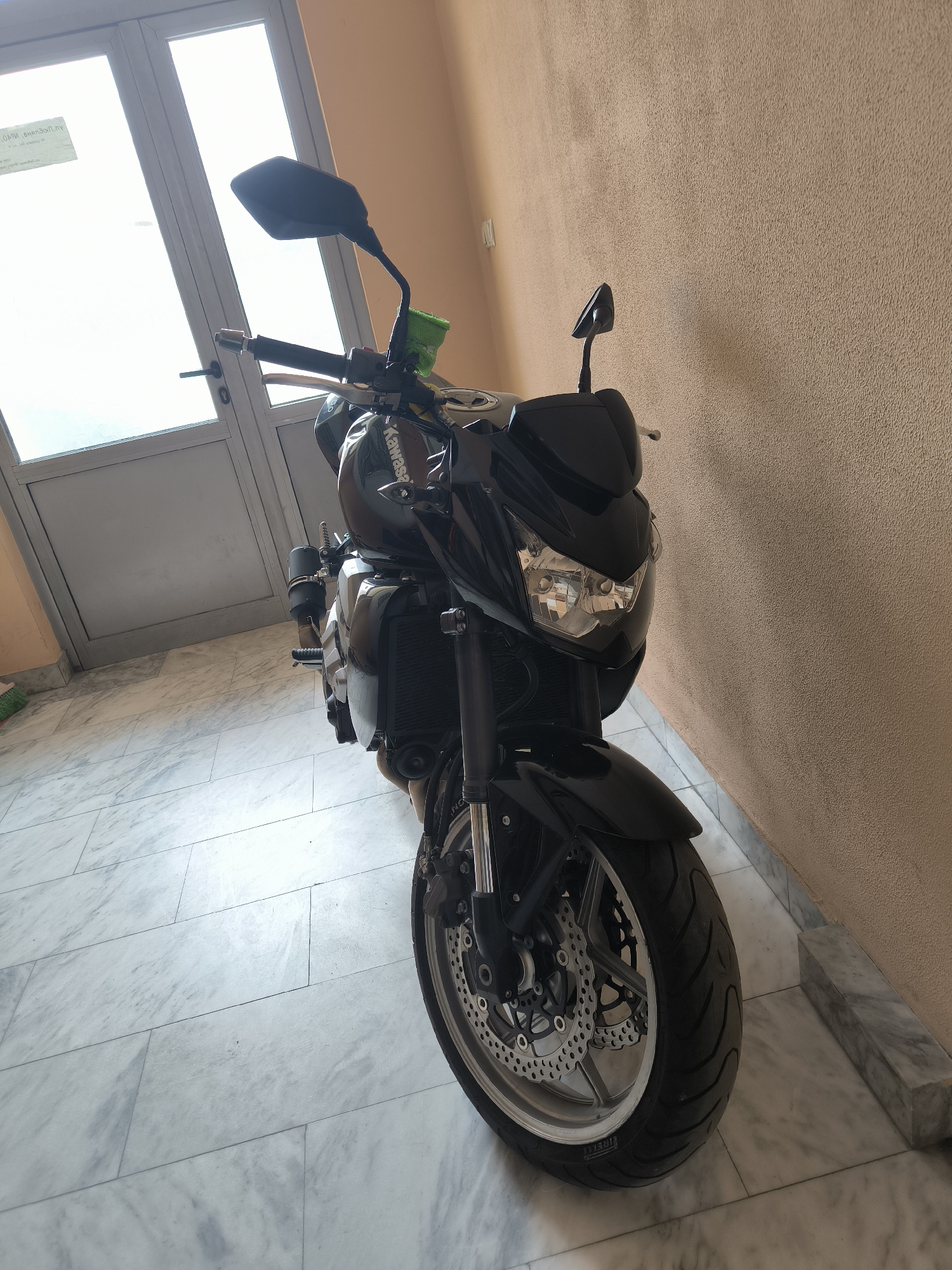 Black Kawasaki motorcycle parked indoors in Sofia, Bulgaria