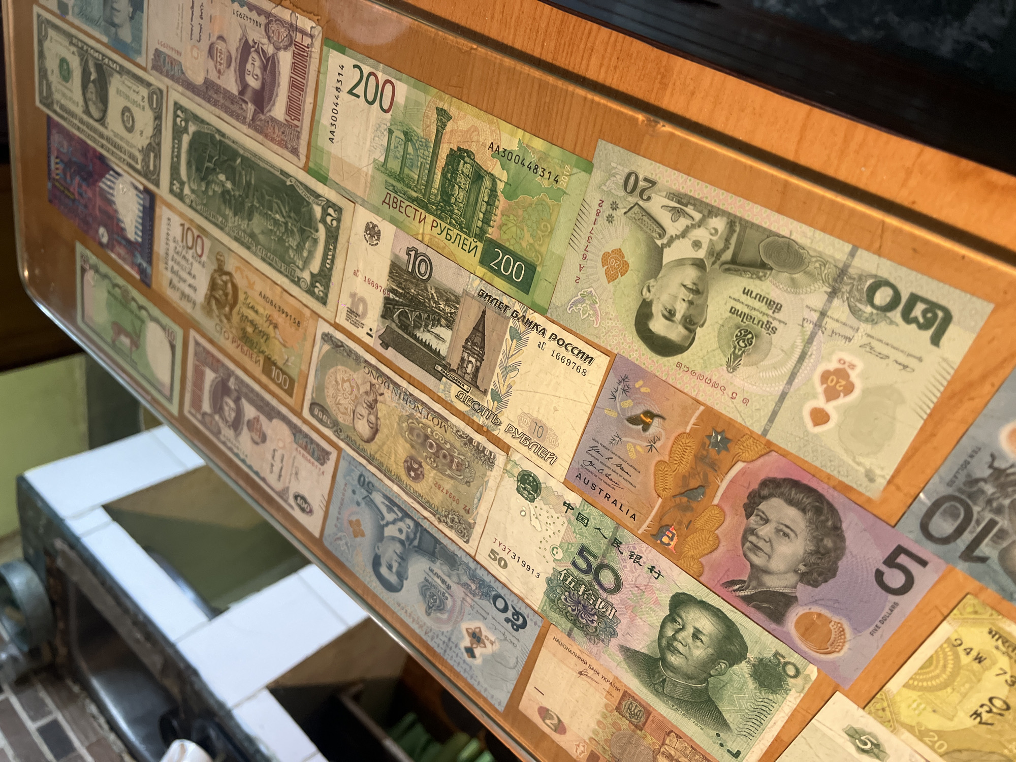 International currency collection displayed in Dharamshala, India