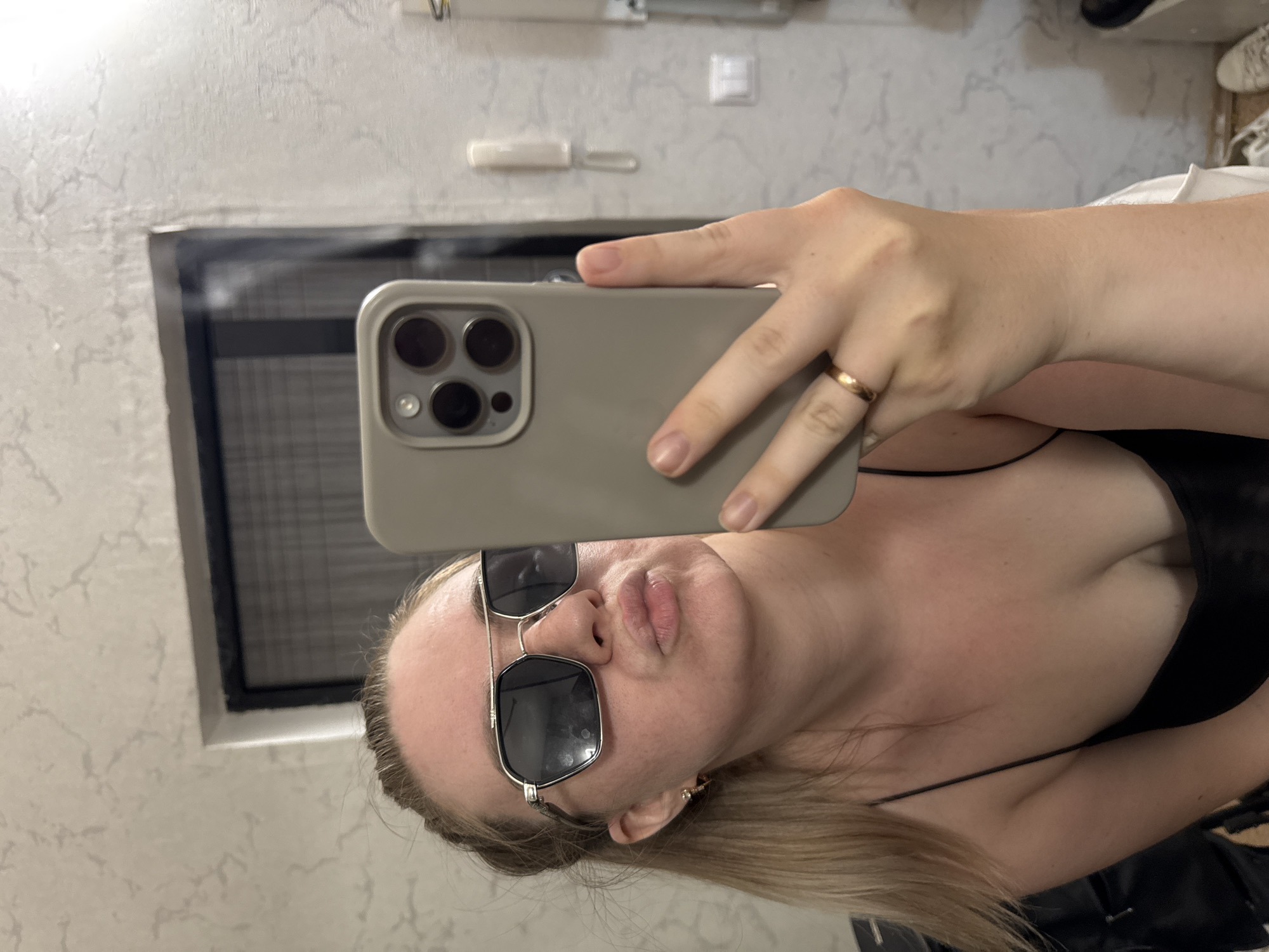 Woman takes mirror selfie in Chaikovsky apartment