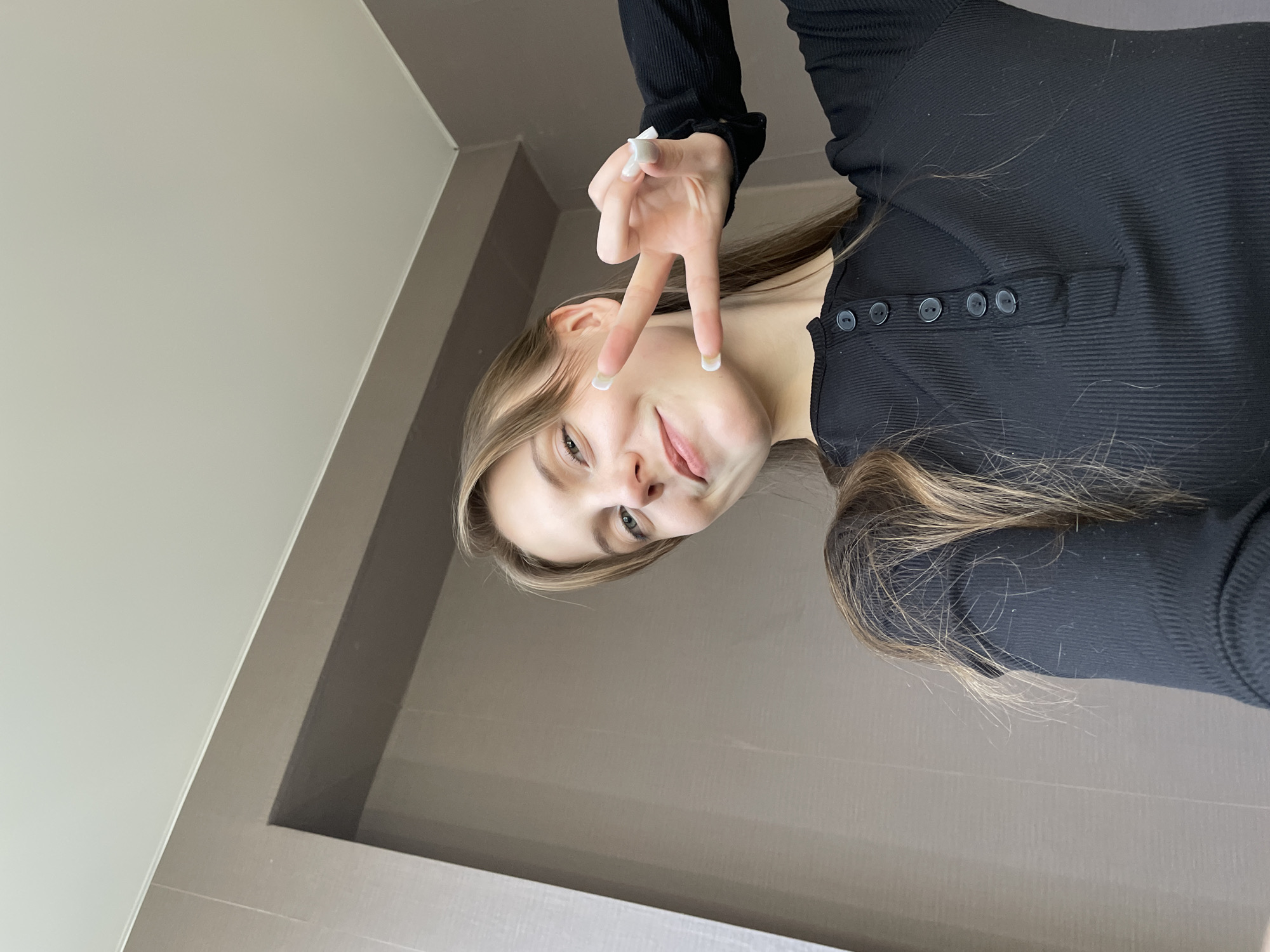 Young woman takes selfies indoors in Ufa, Russia