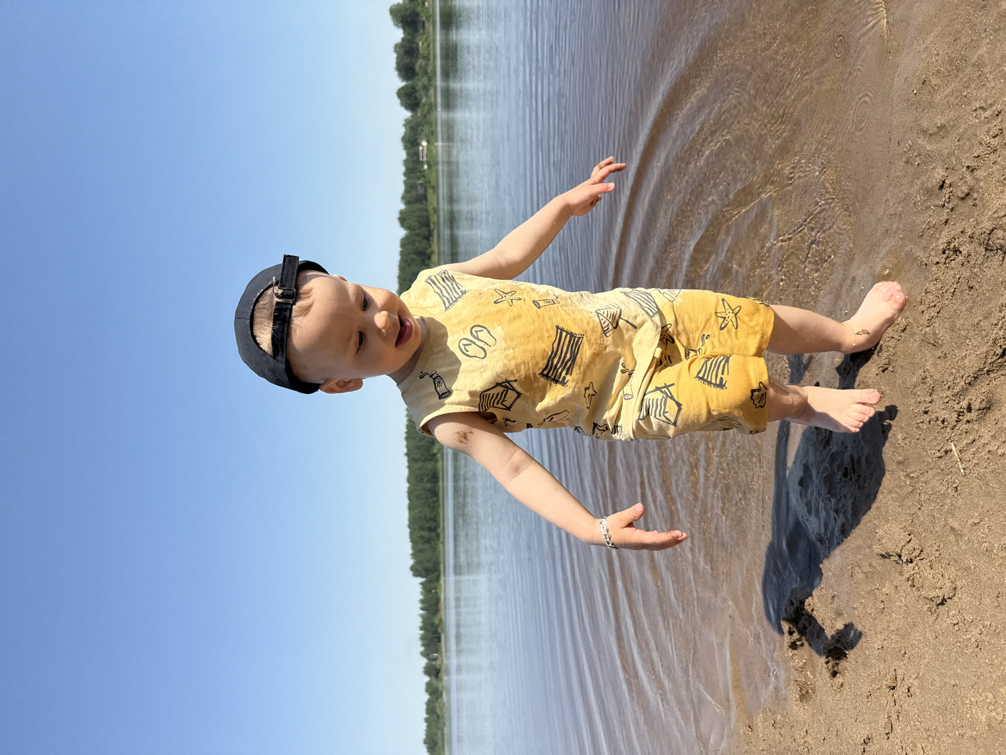 Toddler plays on beach in Rusanovo, Russia