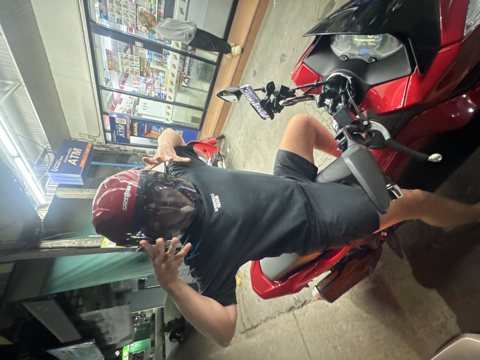 Evening convenience store scene with a motorcycle and a curious dog