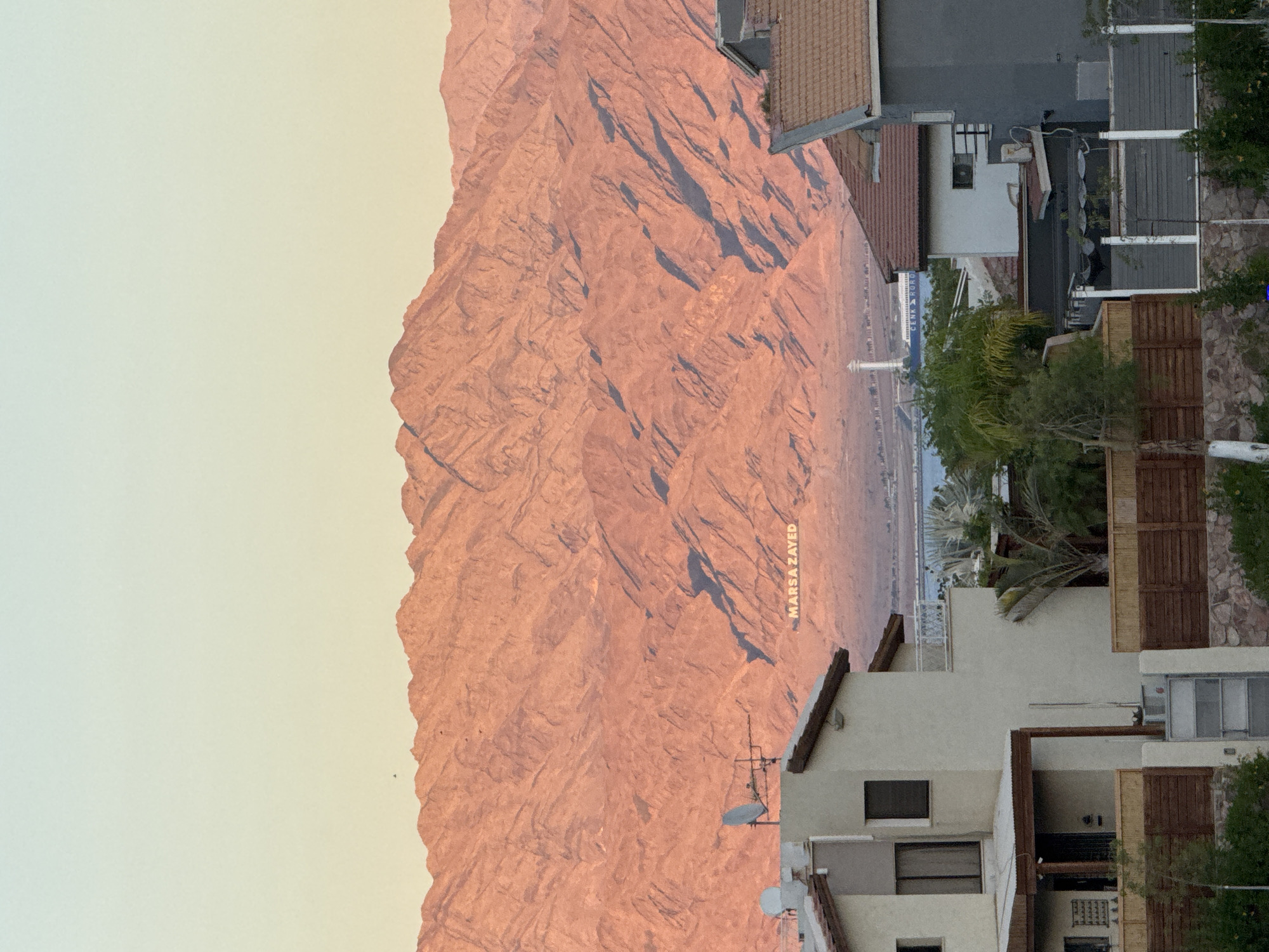 Sunset light over the Eilat Mountains and rooftops below