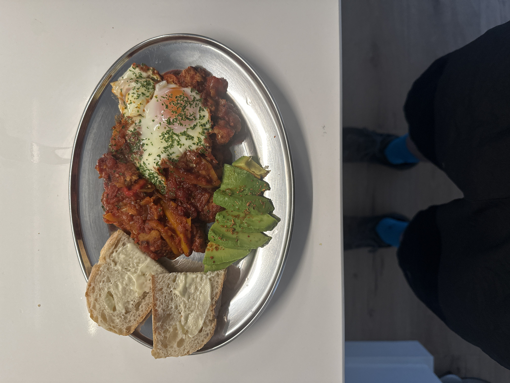 London resident prepares shakshuka breakfast in home kitchen