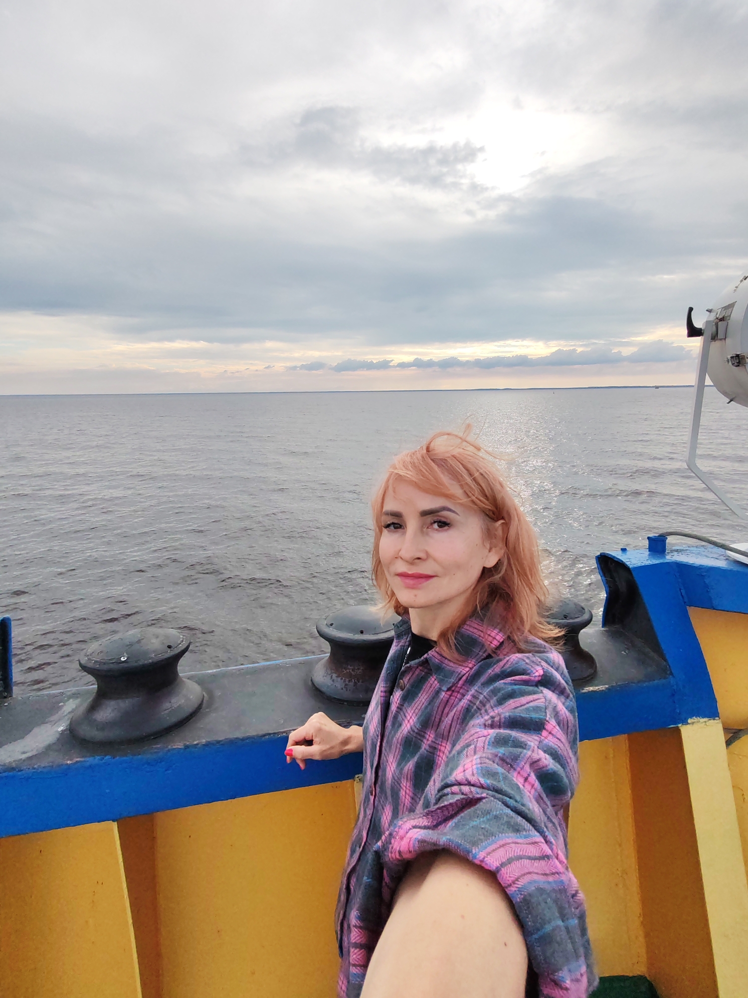 Aboard a boat on open Russian waters, cloudy afternoon